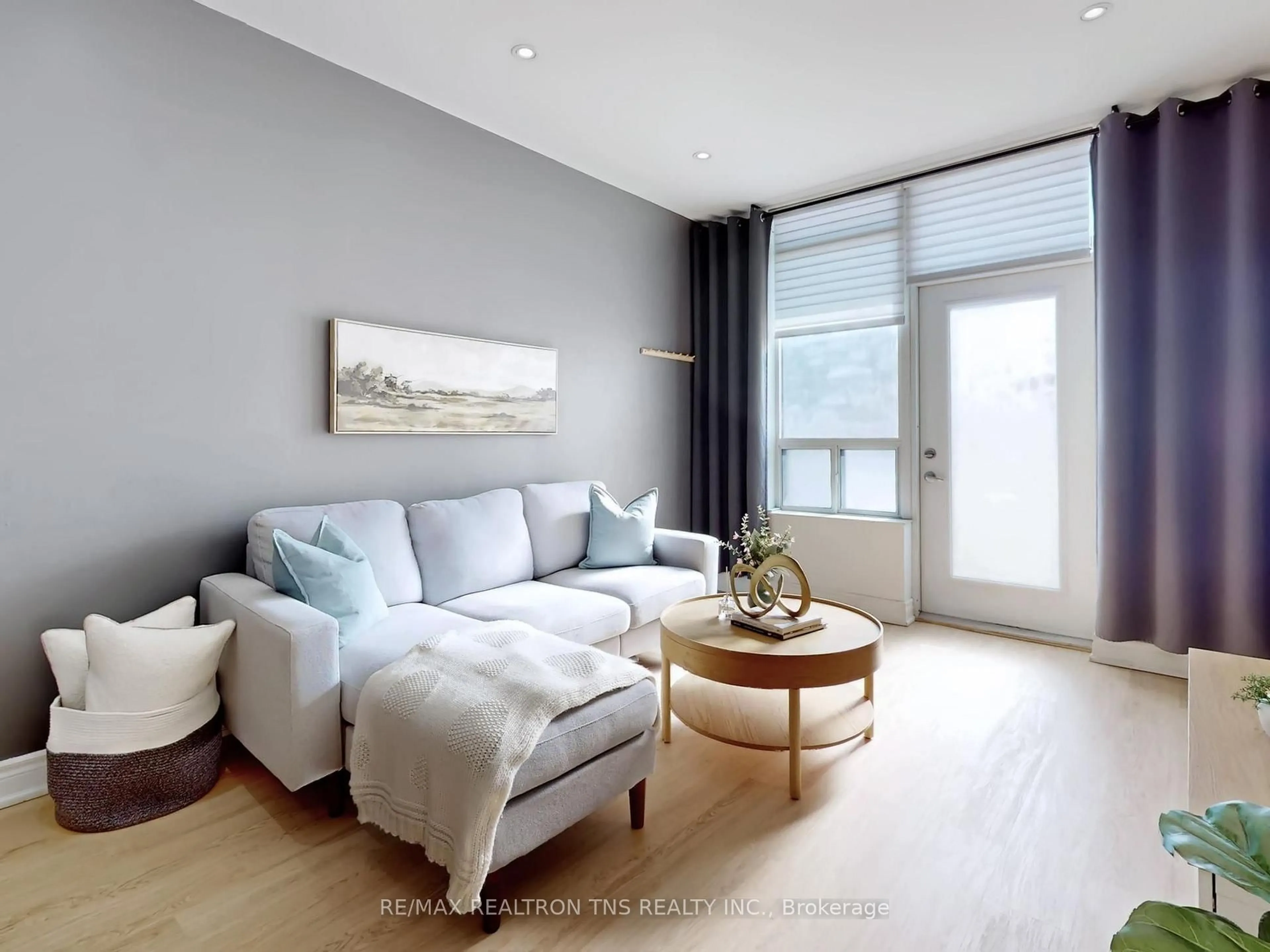Living room with furniture, wood/laminate floor for 88 Times Ave #101, Markham Ontario L3T 7Z4