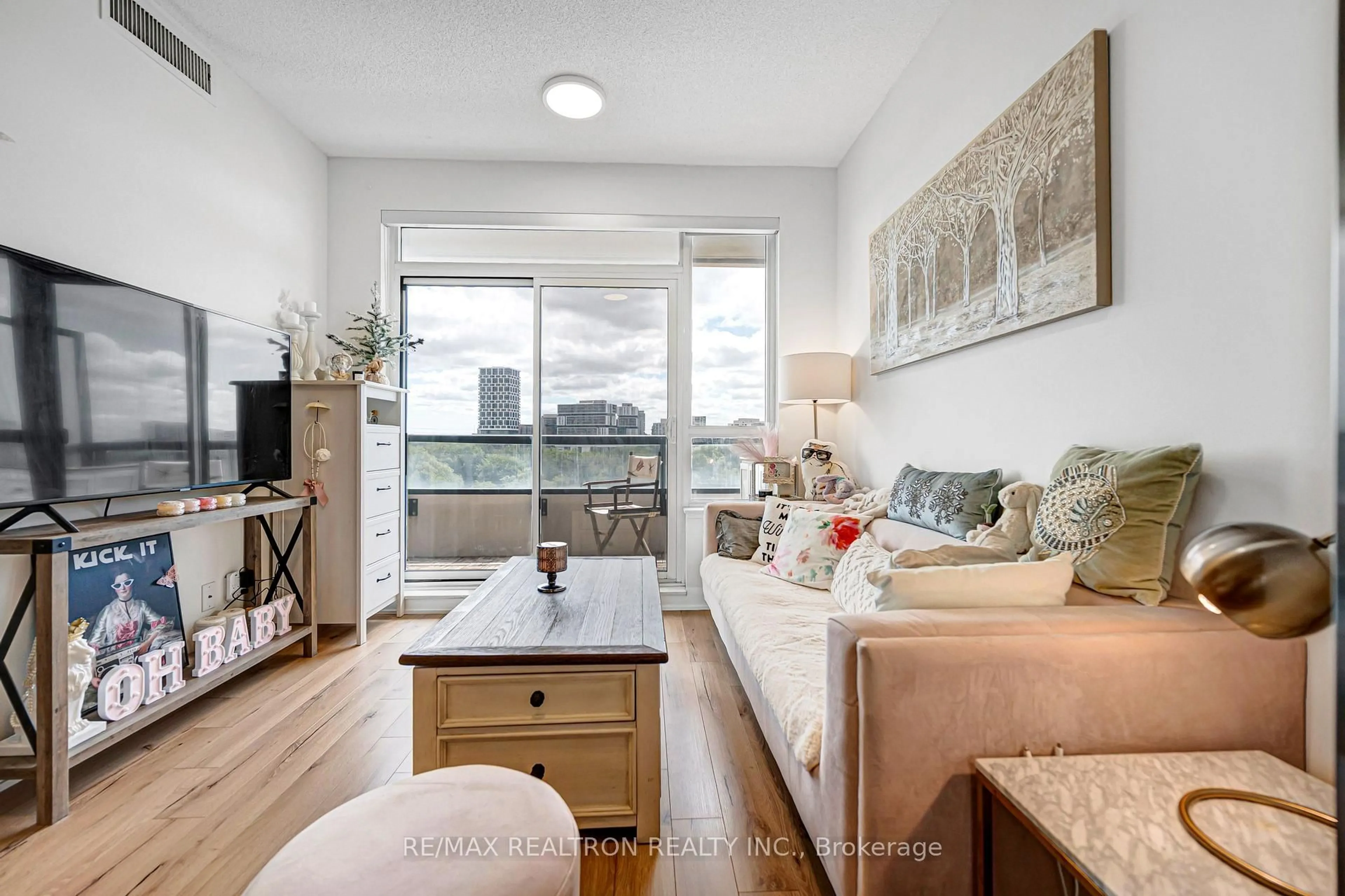 Living room with furniture, wood/laminate floor for 15 Water Walk Dr #715, Markham Ontario L6G 0G2