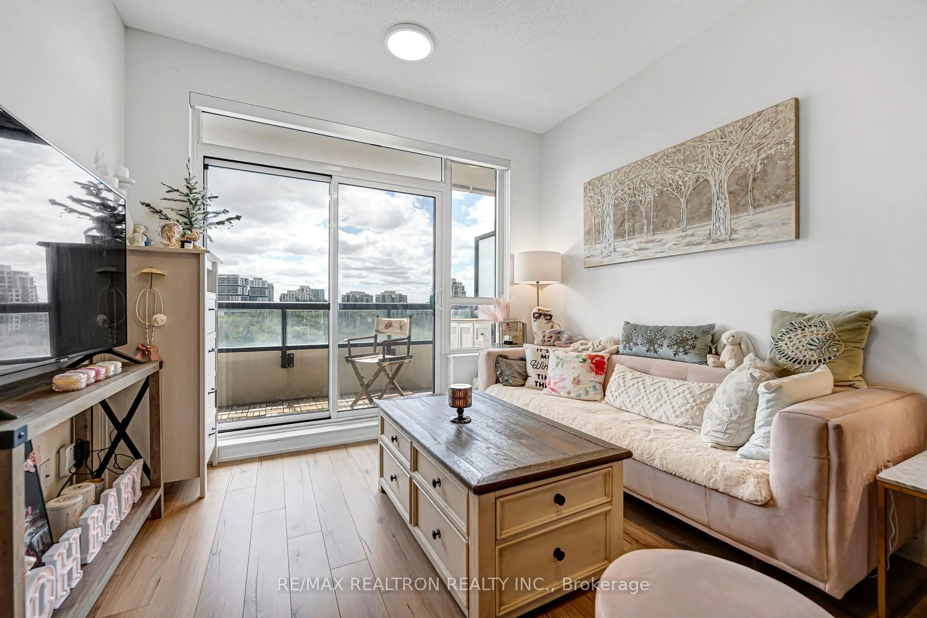 Living room with furniture, wood/laminate floor for 15 Water Walk Dr #715, Markham Ontario L6G 0G2