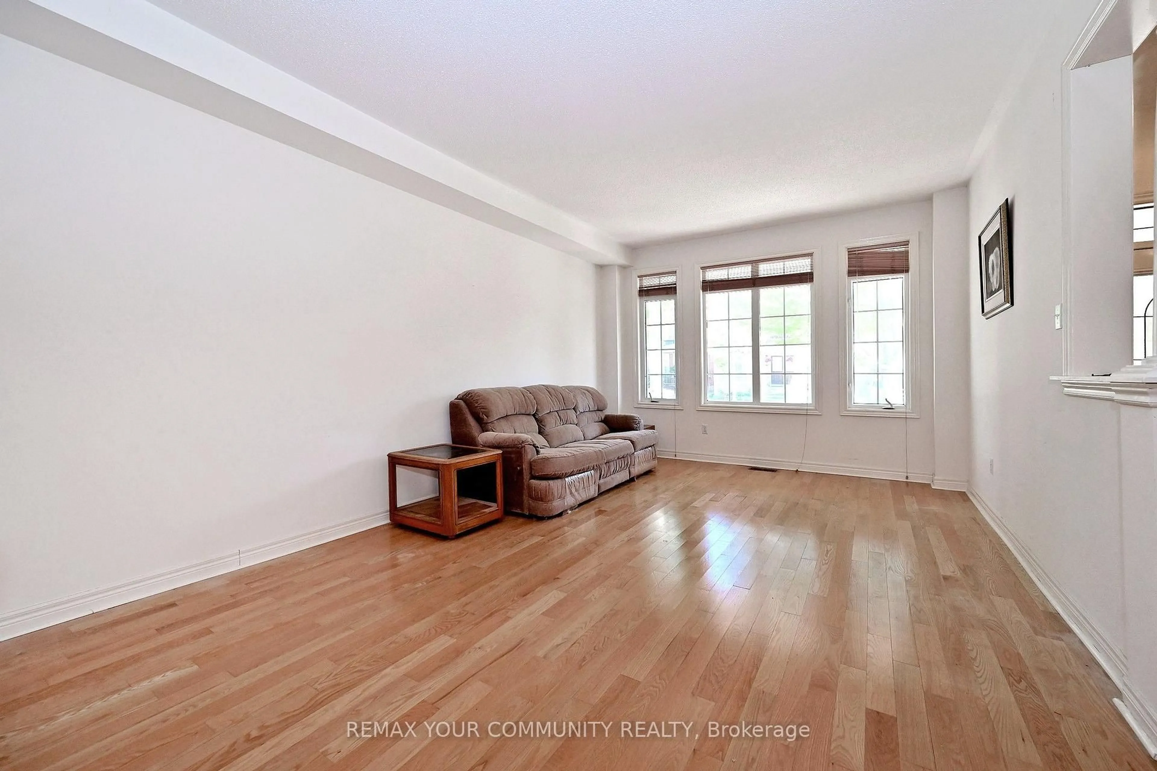 Living room with furniture, wood/laminate floor for 14 Houser St, Markham Ontario L6E 1H9