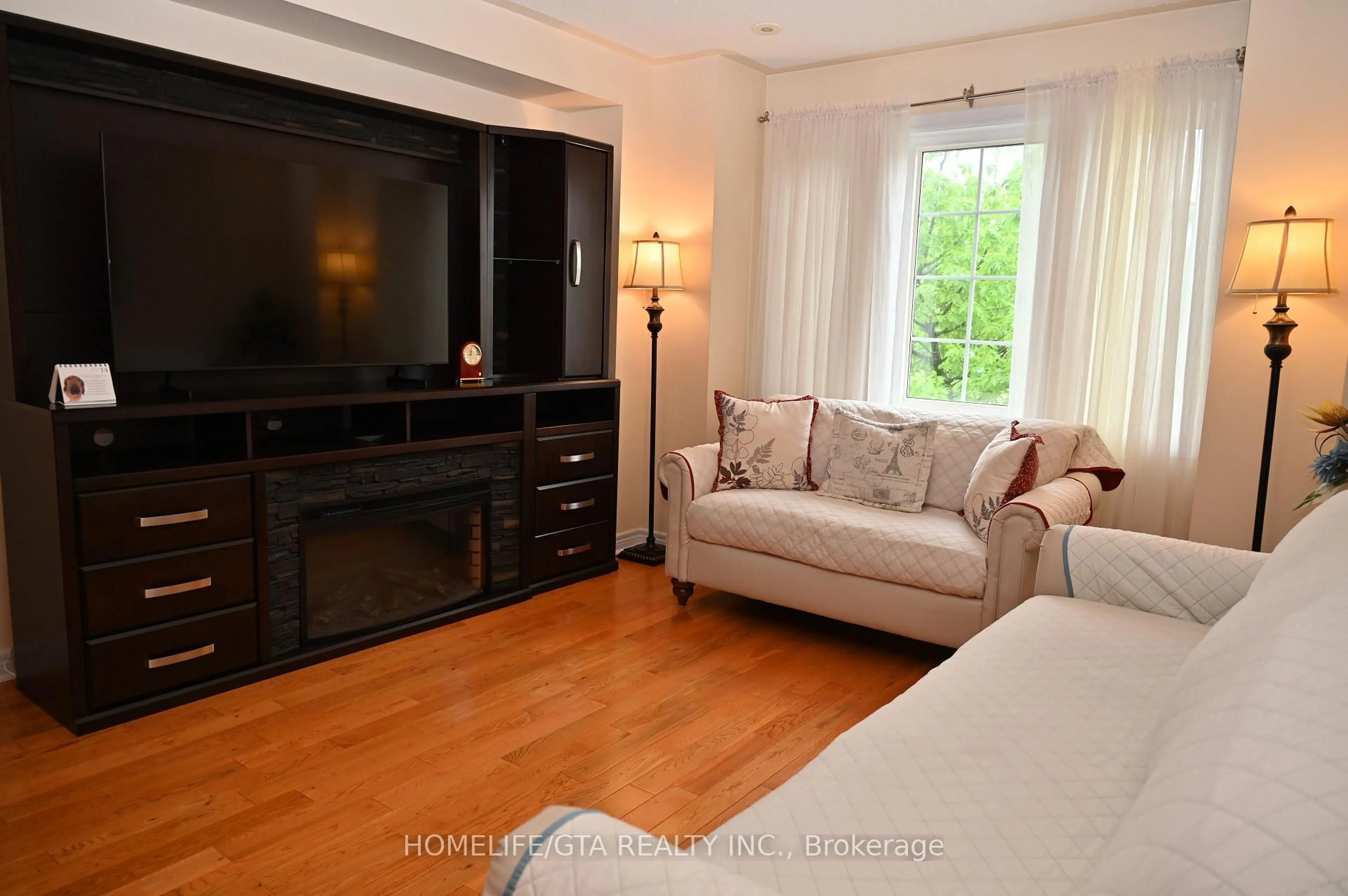 Living room with furniture, wood/laminate floor for 2532 Bur Oak Ave, Markham Ontario L6B 1H2