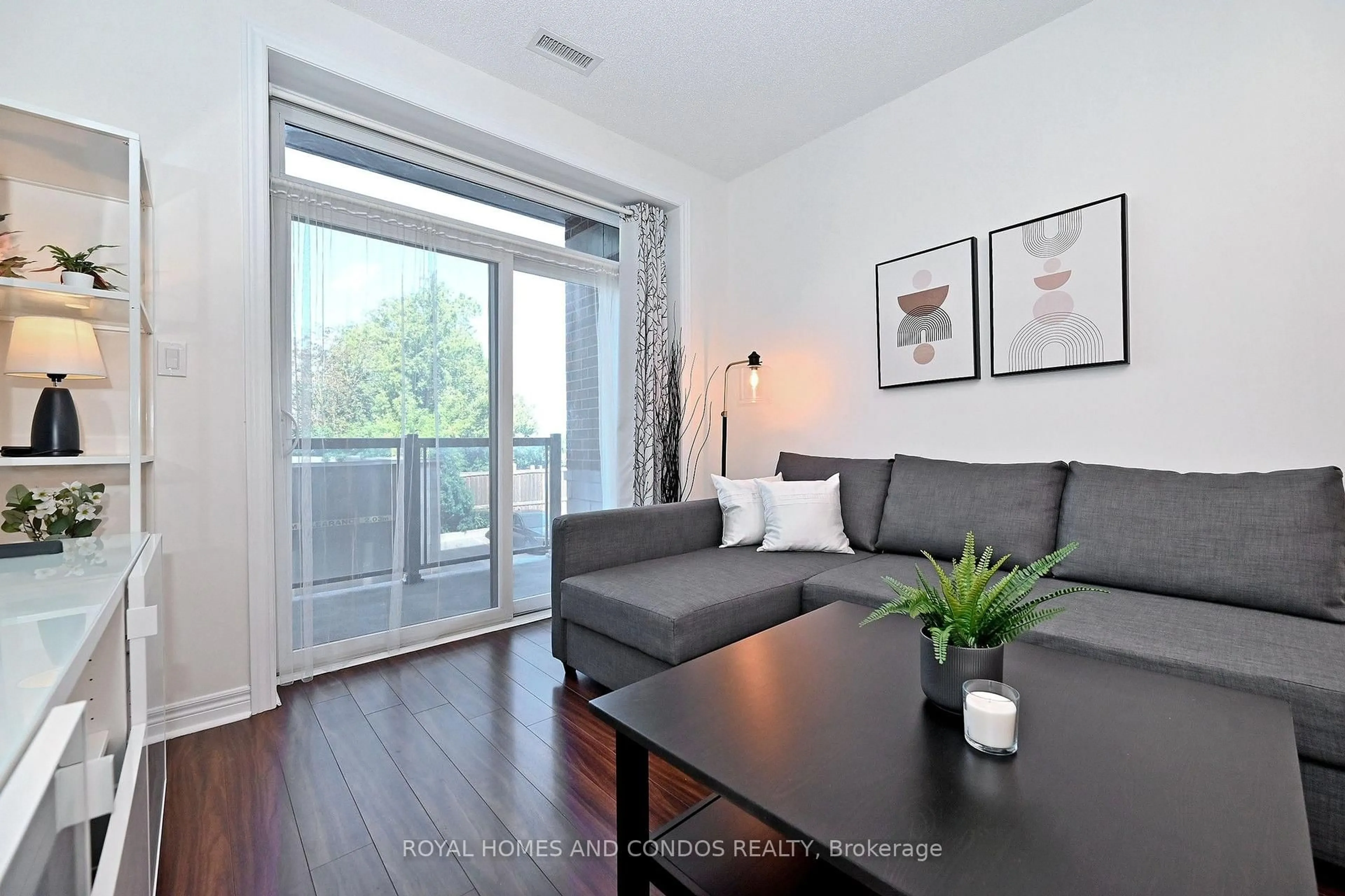 Living room with furniture, wood/laminate floor for 7768 Kennedy Rd #203, Markham Ontario L3R 5K1