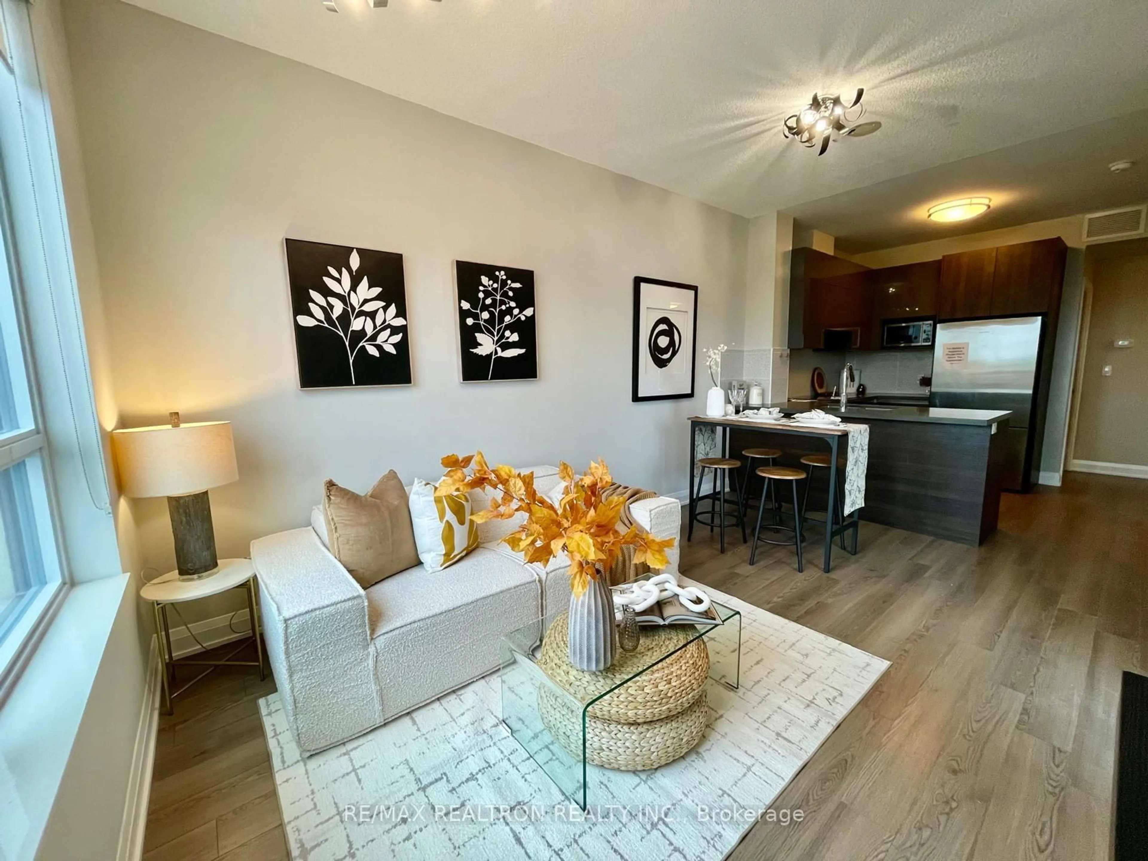 Living room with furniture, wood/laminate floor for 25 Water Walk Dr #516, Markham Ontario L3P 1N3
