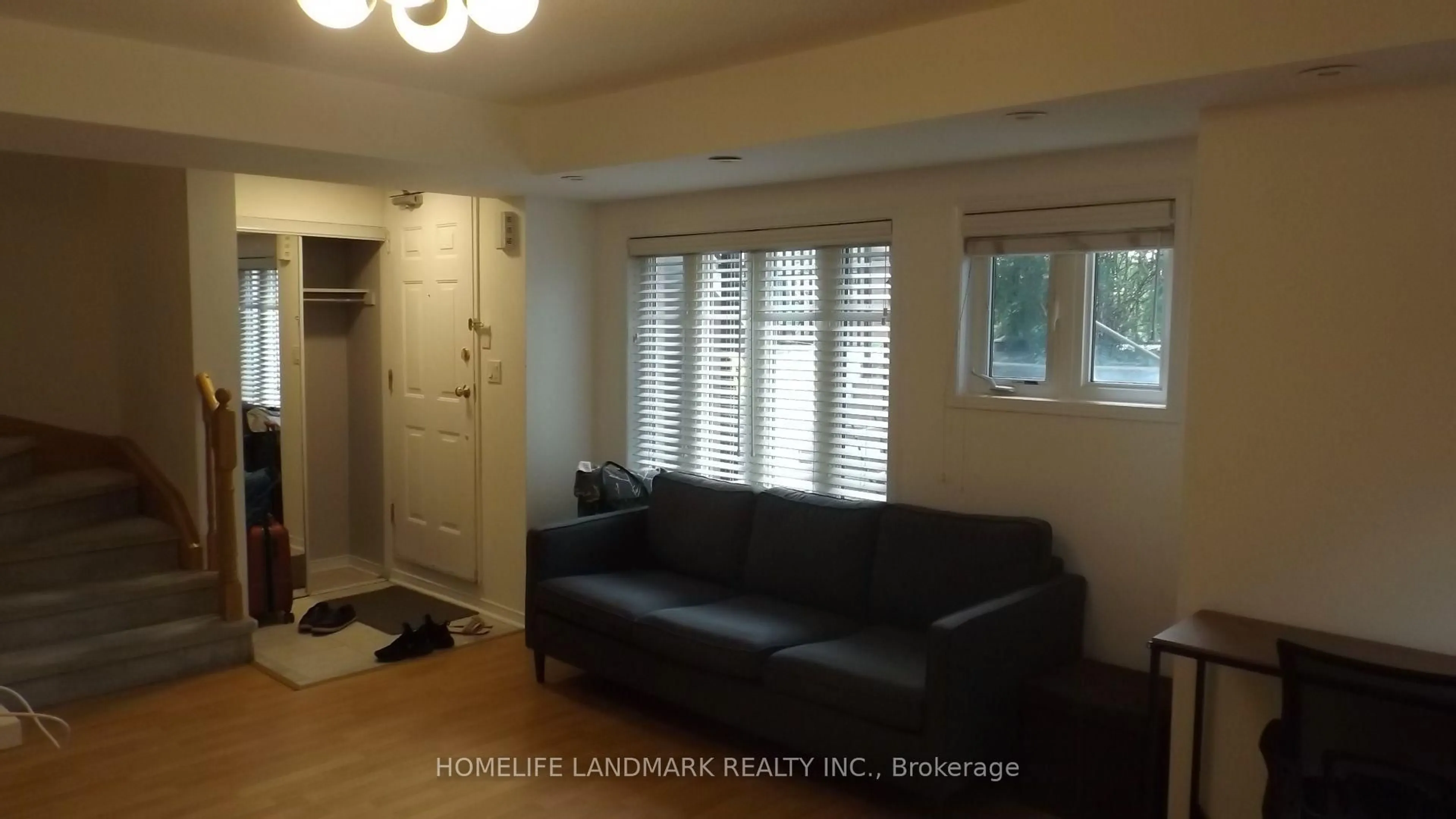 Living room with furniture, wood/laminate floor for 306 John St #151, Markham Ontario L3T 0A7