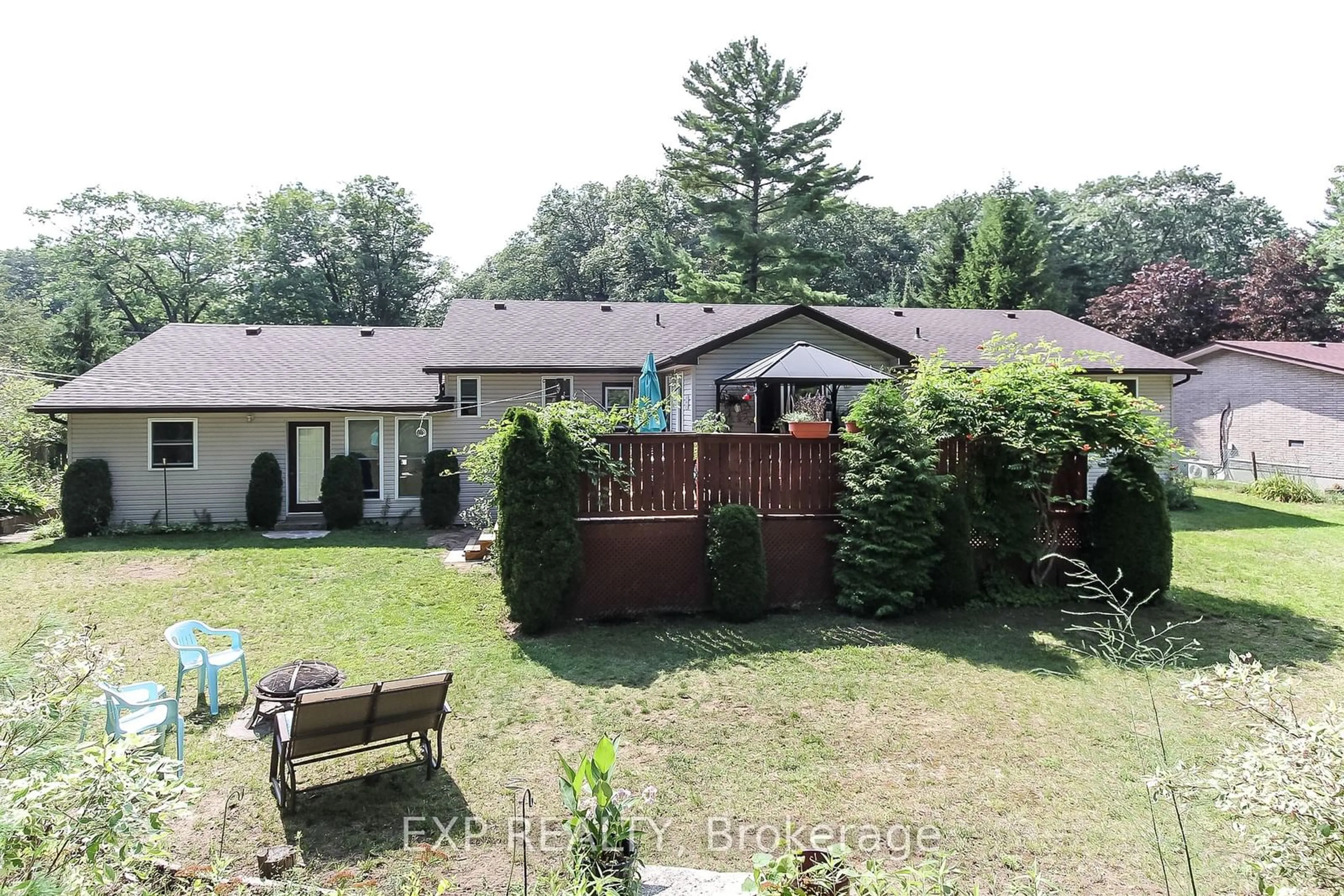 Frontside or backside of a home, the fenced backyard for 225 39th St, Wasaga Beach Ontario L9A 1S3