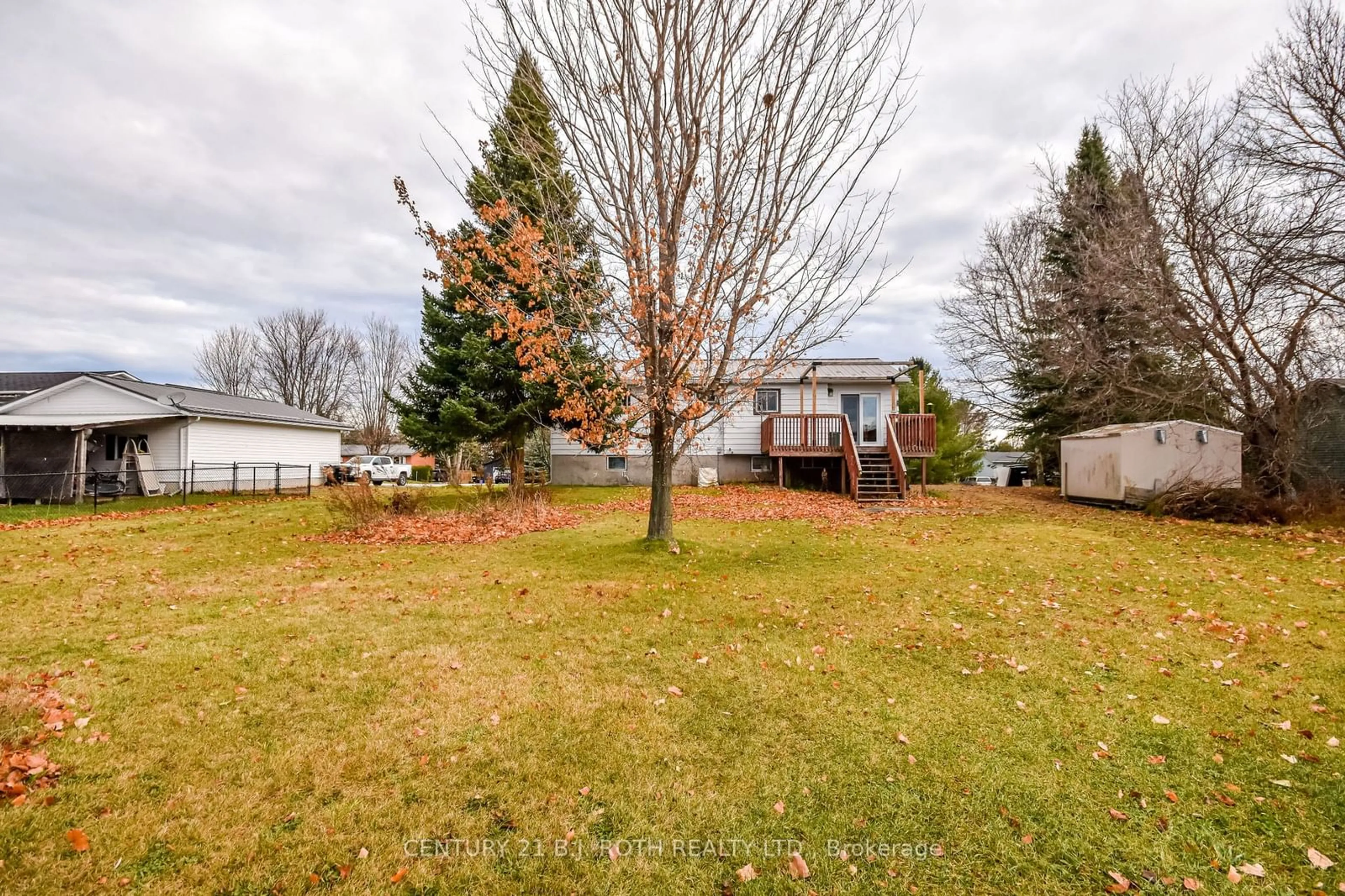 Frontside or backside of a home, the fenced backyard for 14 Preston St, Oro-Medonte Ontario L0K 2G0