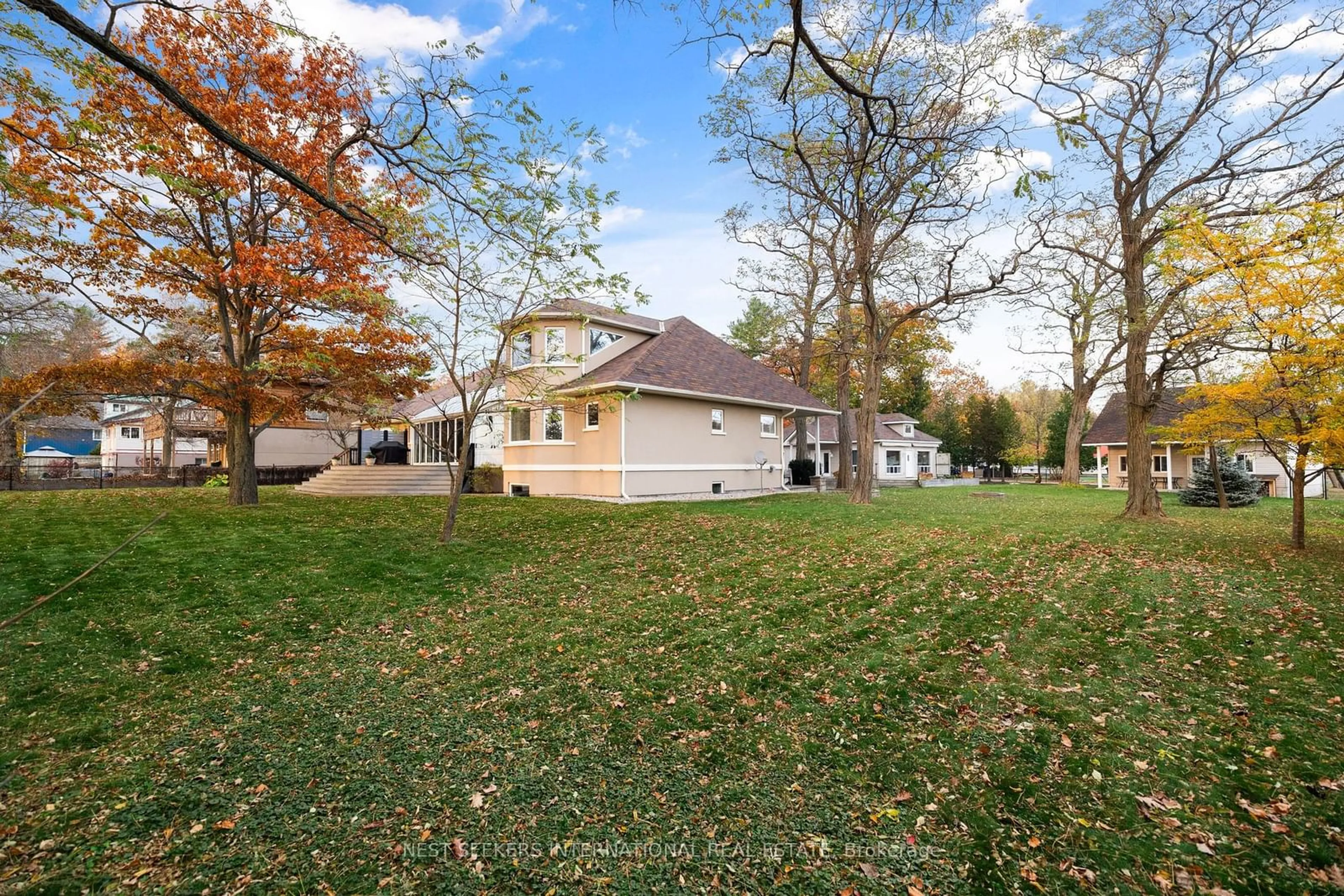 Frontside or backside of a home, the fenced backyard for 20 Tiny Beaches Rd, Tiny Ontario L0L 2J0