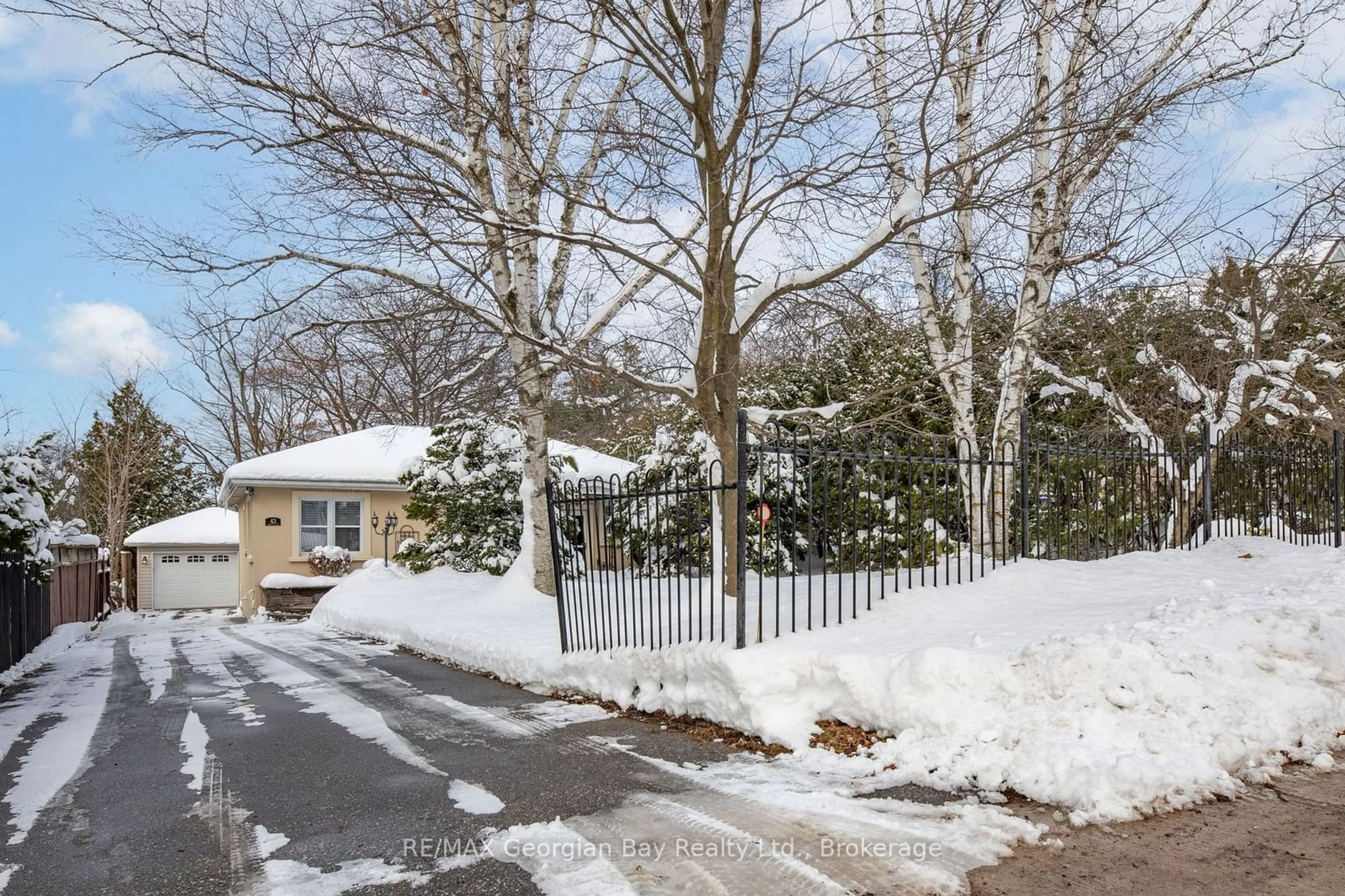 A pic from exterior of the house or condo, the fenced backyard for 43 Robert St, Penetanguishene Ontario L9M 1B1