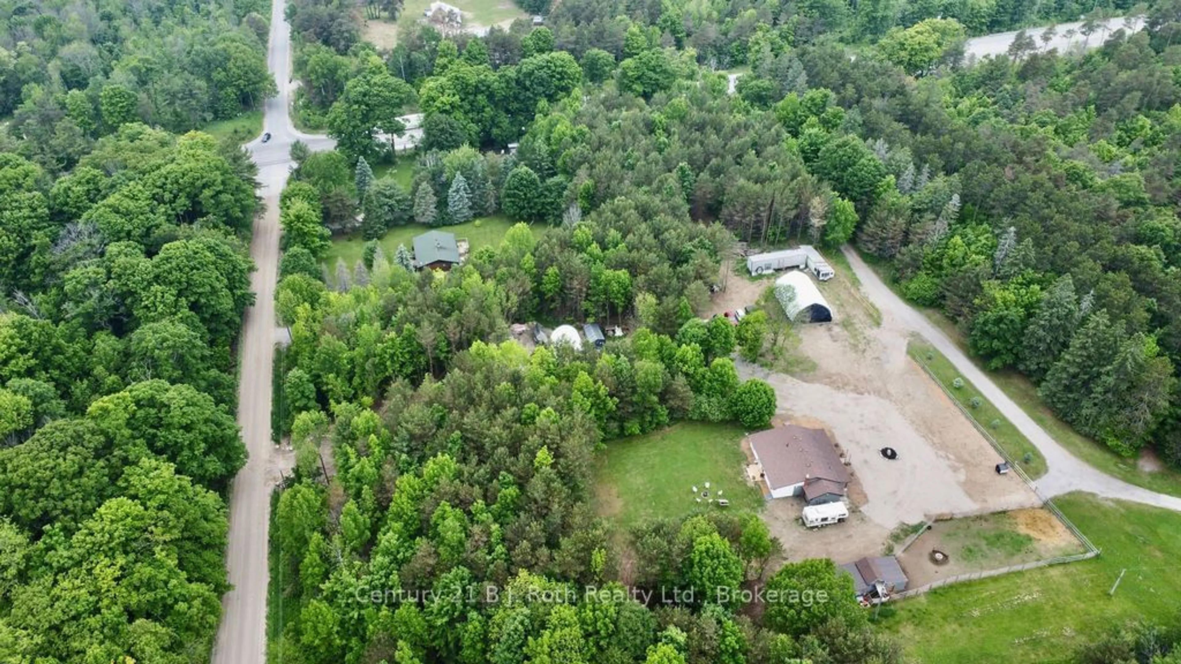 A pic from outside/outdoor area/front of a property/back of a property/a pic from drone, forest/trees view for 5989 Penetanguishene Rd, Springwater Ontario L0L 1P0