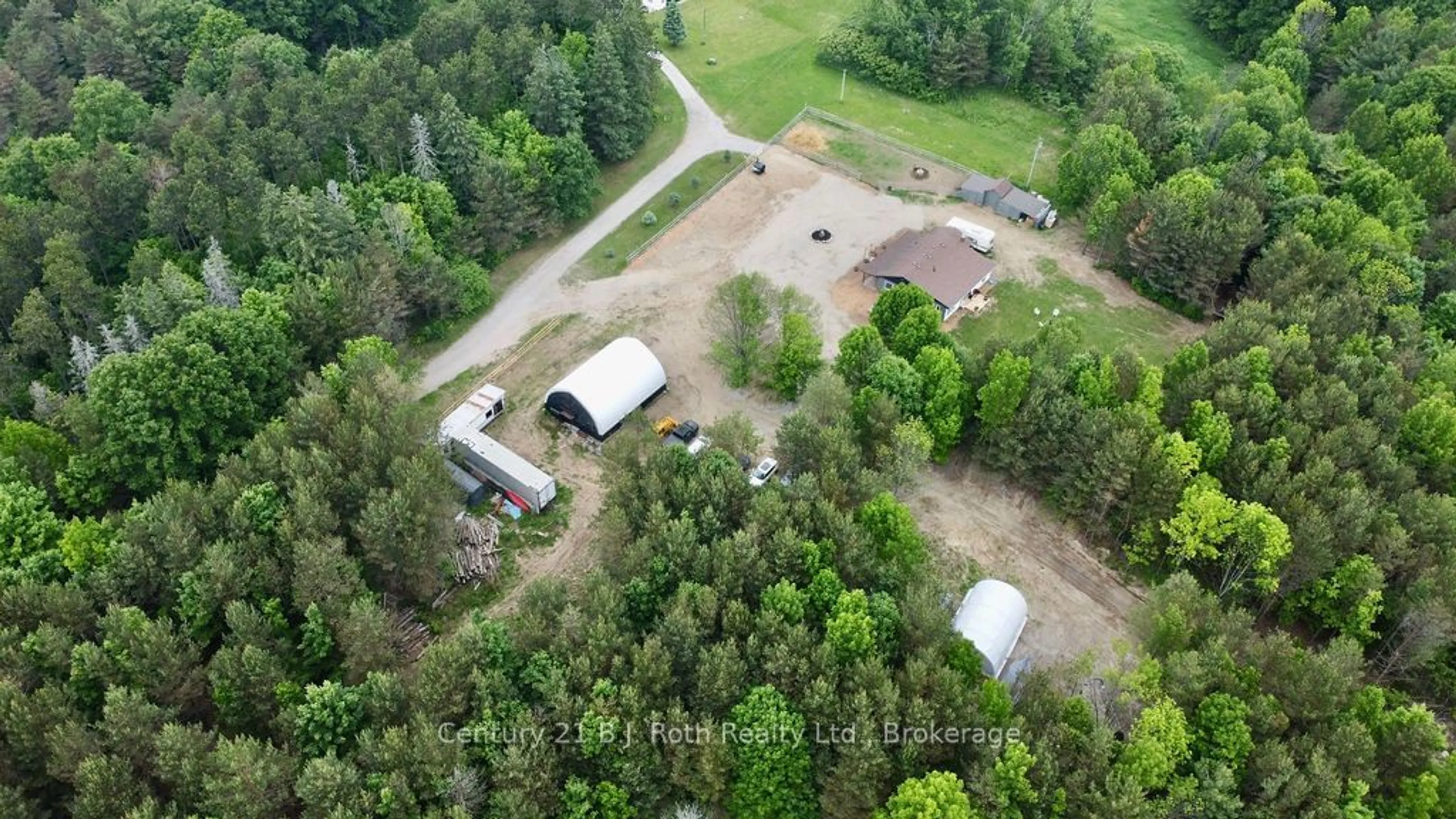 A pic from outside/outdoor area/front of a property/back of a property/a pic from drone, forest/trees view for 5989 Penetanguishene Rd, Springwater Ontario L0L 1P0