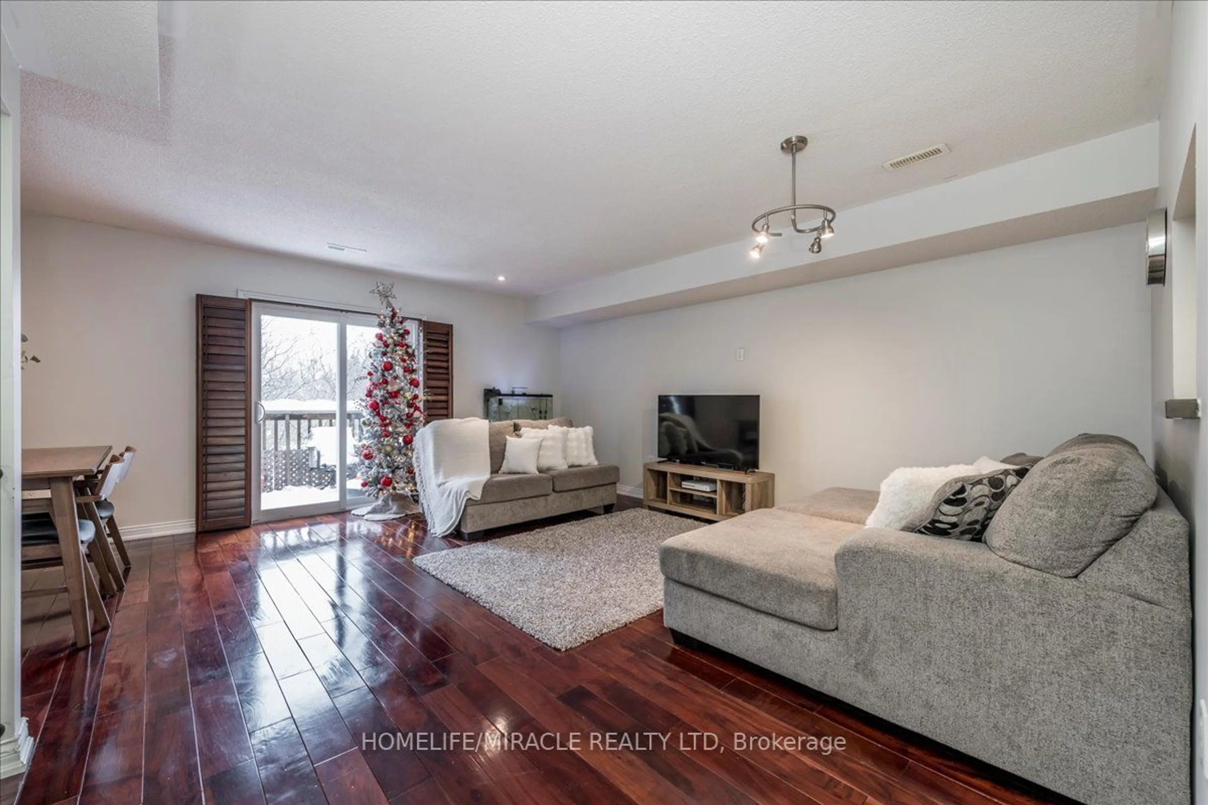 Living room with furniture, wood/laminate floor for 119 D'AMBROSIO Dr #51, Barrie Ontario L4N 7R7