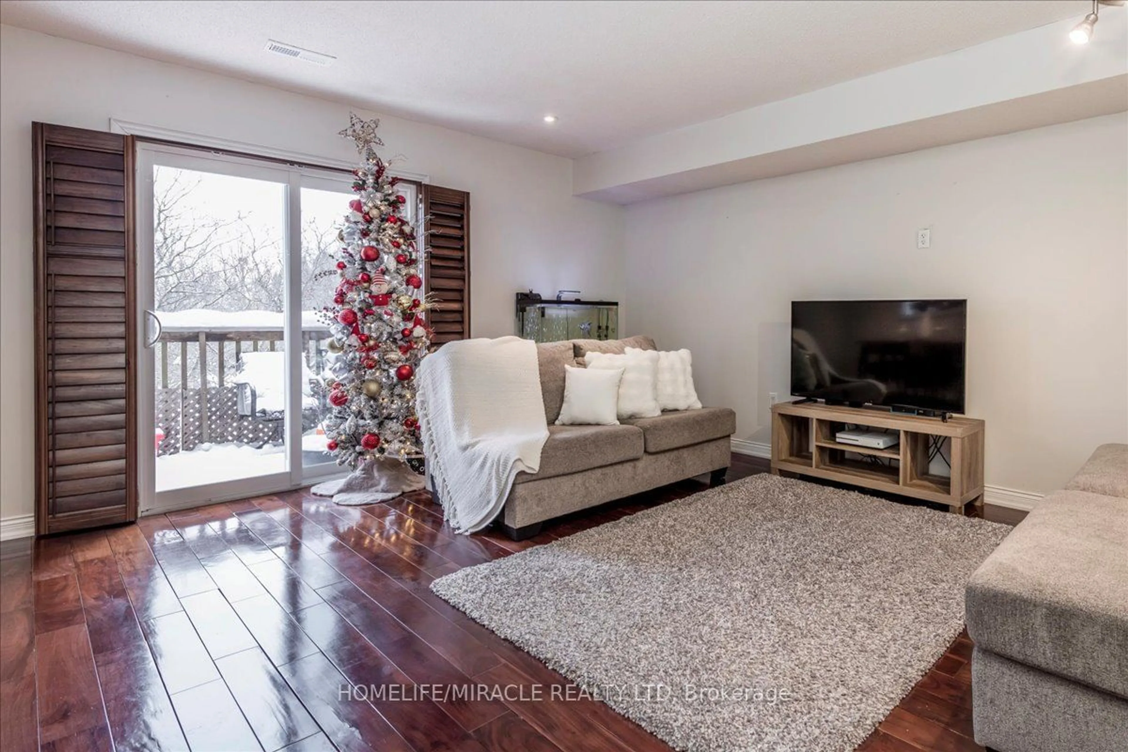 Living room with furniture, wood/laminate floor for 119 D'AMBROSIO Dr #51, Barrie Ontario L4N 7R7