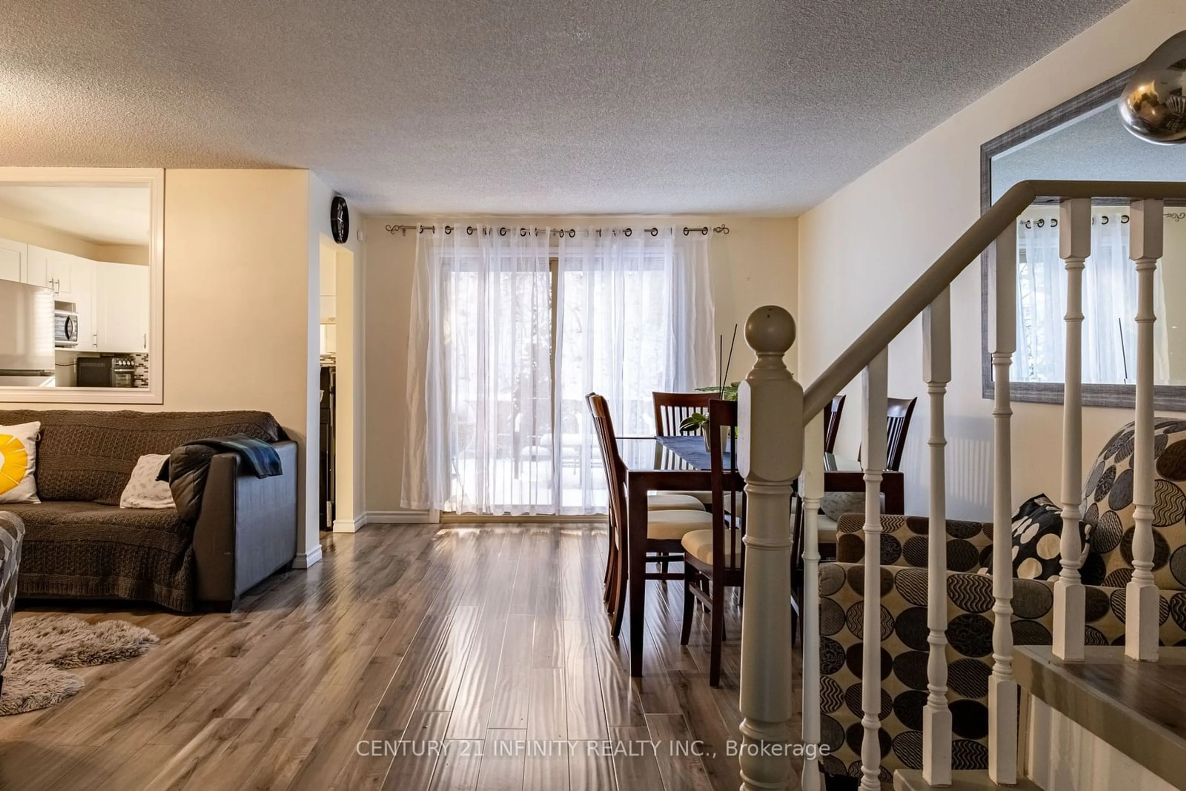 Living room with furniture, wood/laminate floor for 84 Loggers Run #80, Barrie Ontario L4N 6W8