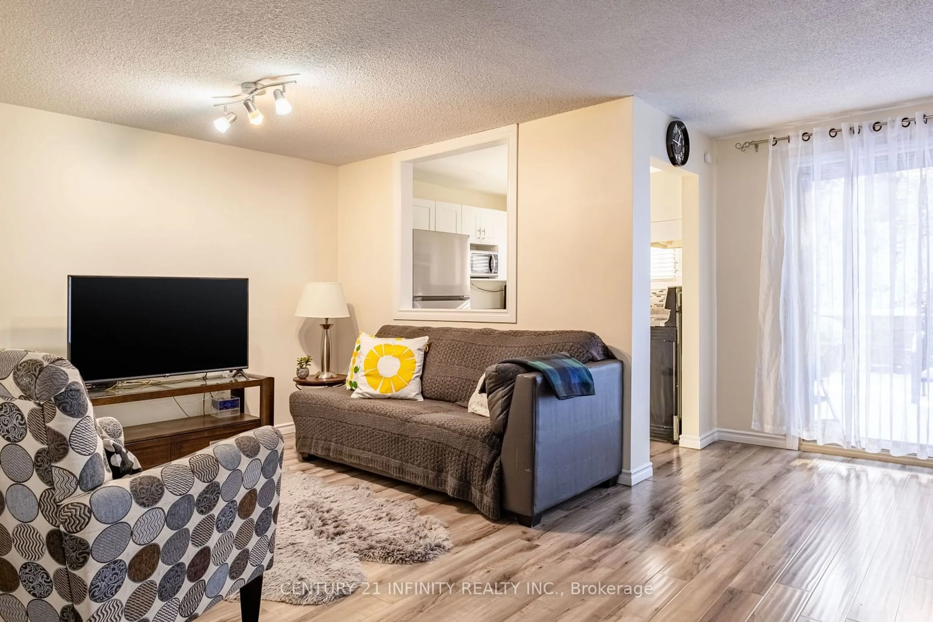 Living room with furniture, wood/laminate floor for 84 Loggers Run #80, Barrie Ontario L4N 6W8