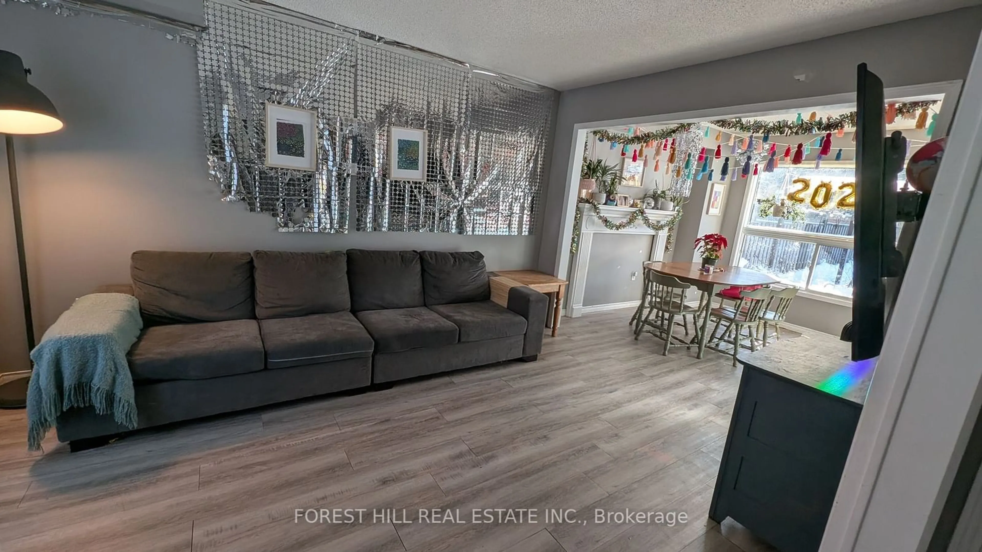 Living room with furniture, wood/laminate floor for 46 Golden Meadow Rd, Barrie Ontario L4N 7G5