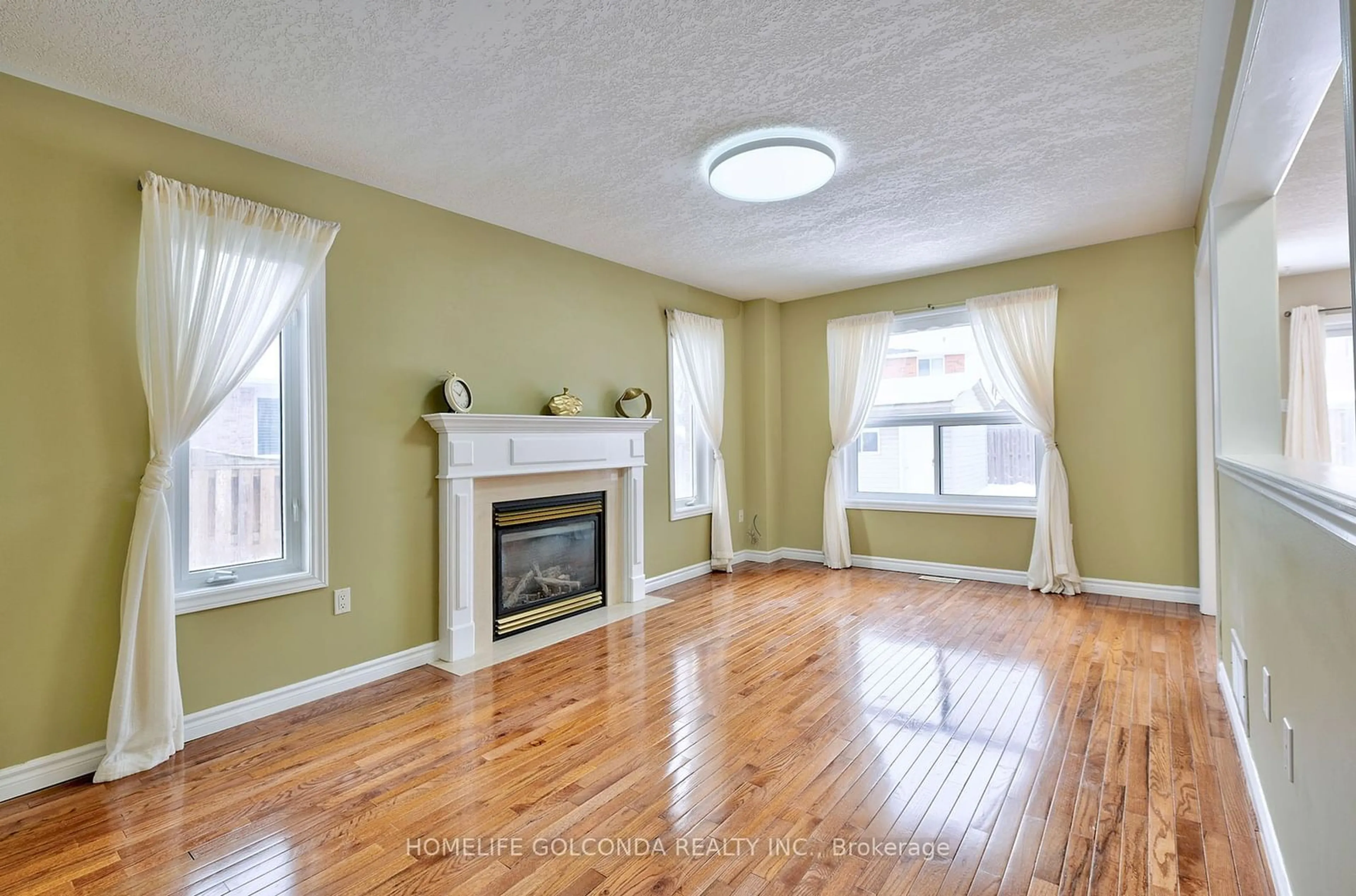 Living room with furniture, wood/laminate floor for 22 Carley Cres, Barrie Ontario L4N 0R8