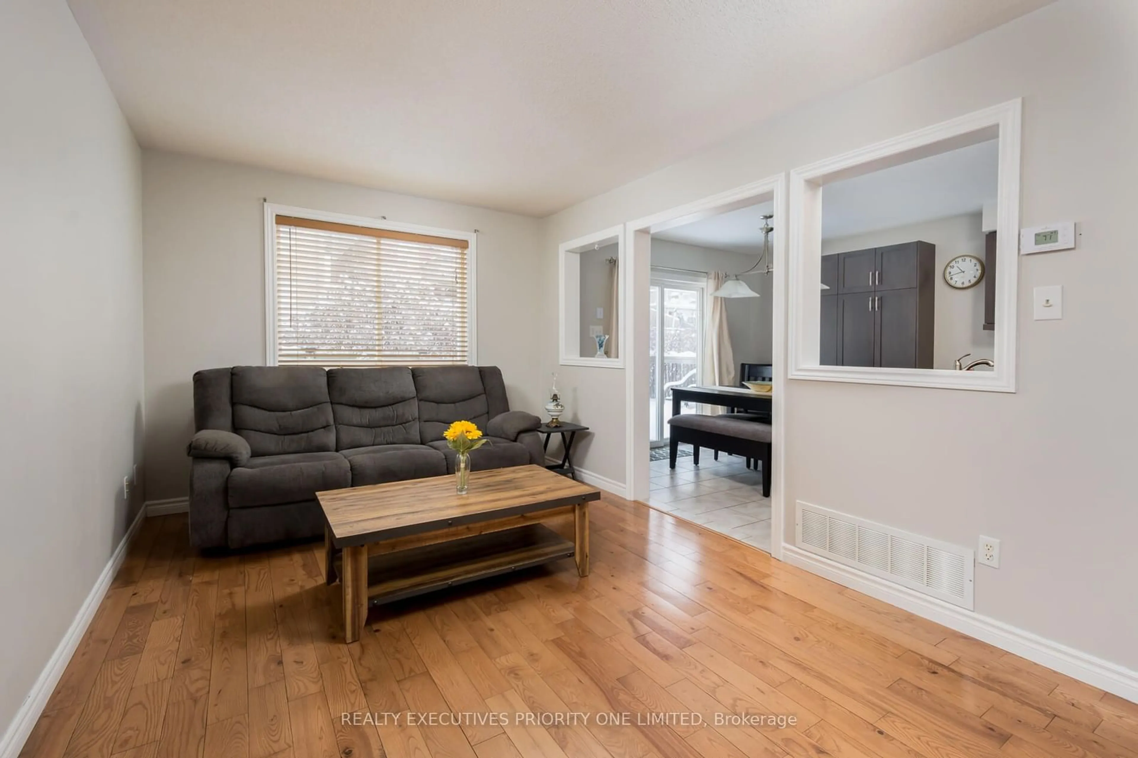 Living room with furniture, wood/laminate floor for 6 Bird St, Barrie Ontario L4N 0X1