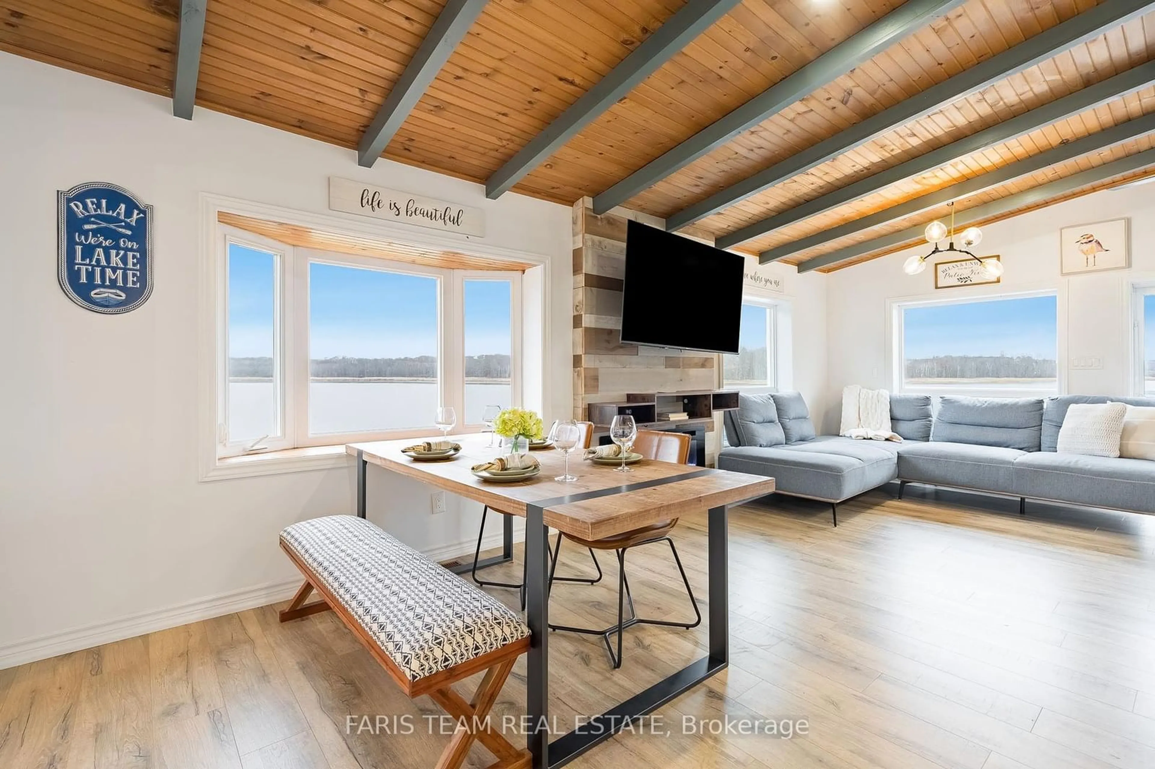 Living room with furniture, wood/laminate floor for 122 Mitchells Beach Rd, Tay Ontario L0K 2A0