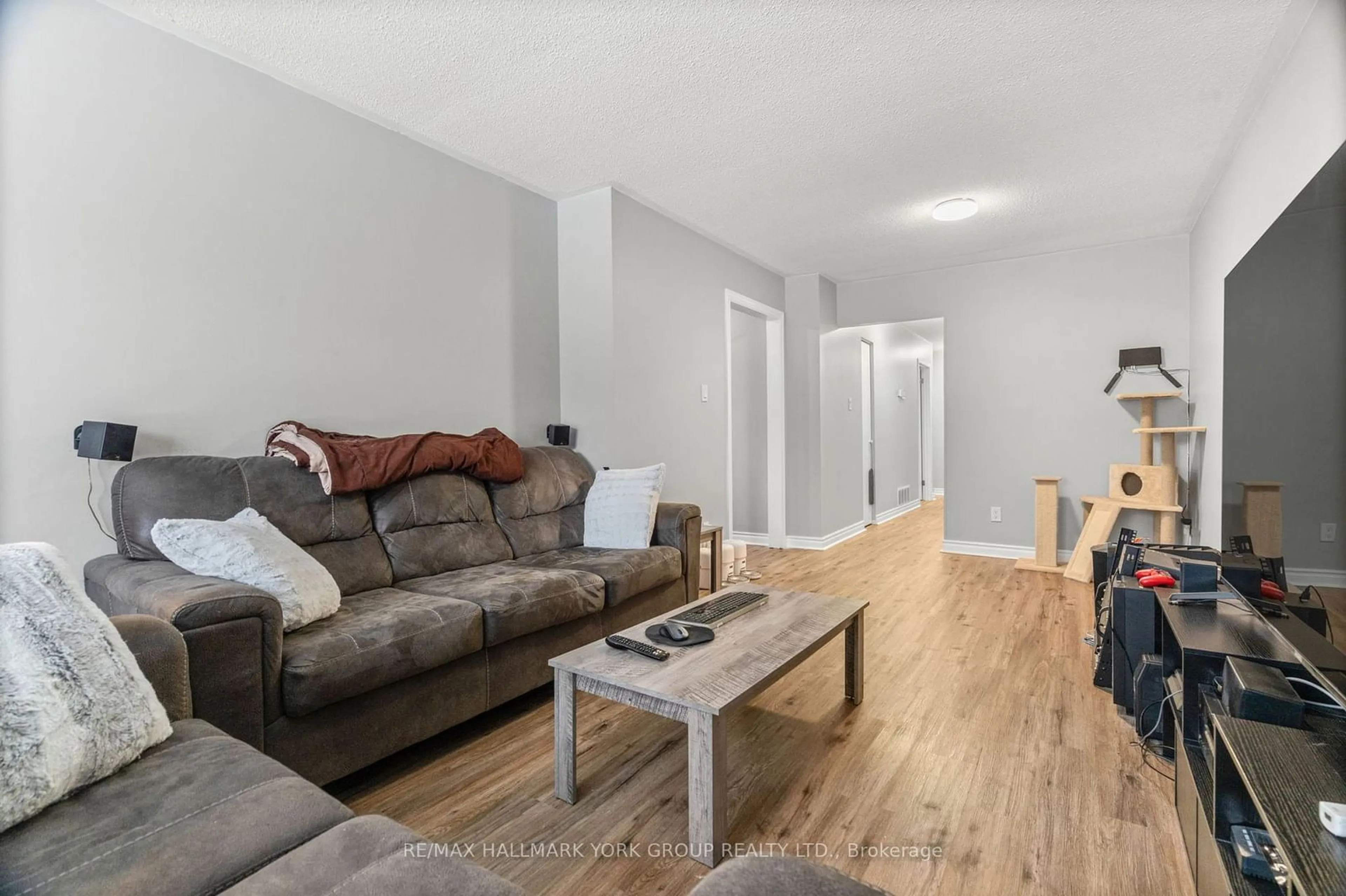 Living room with furniture, wood/laminate floor for 25A College Cres, Barrie Ontario L4M 2W4