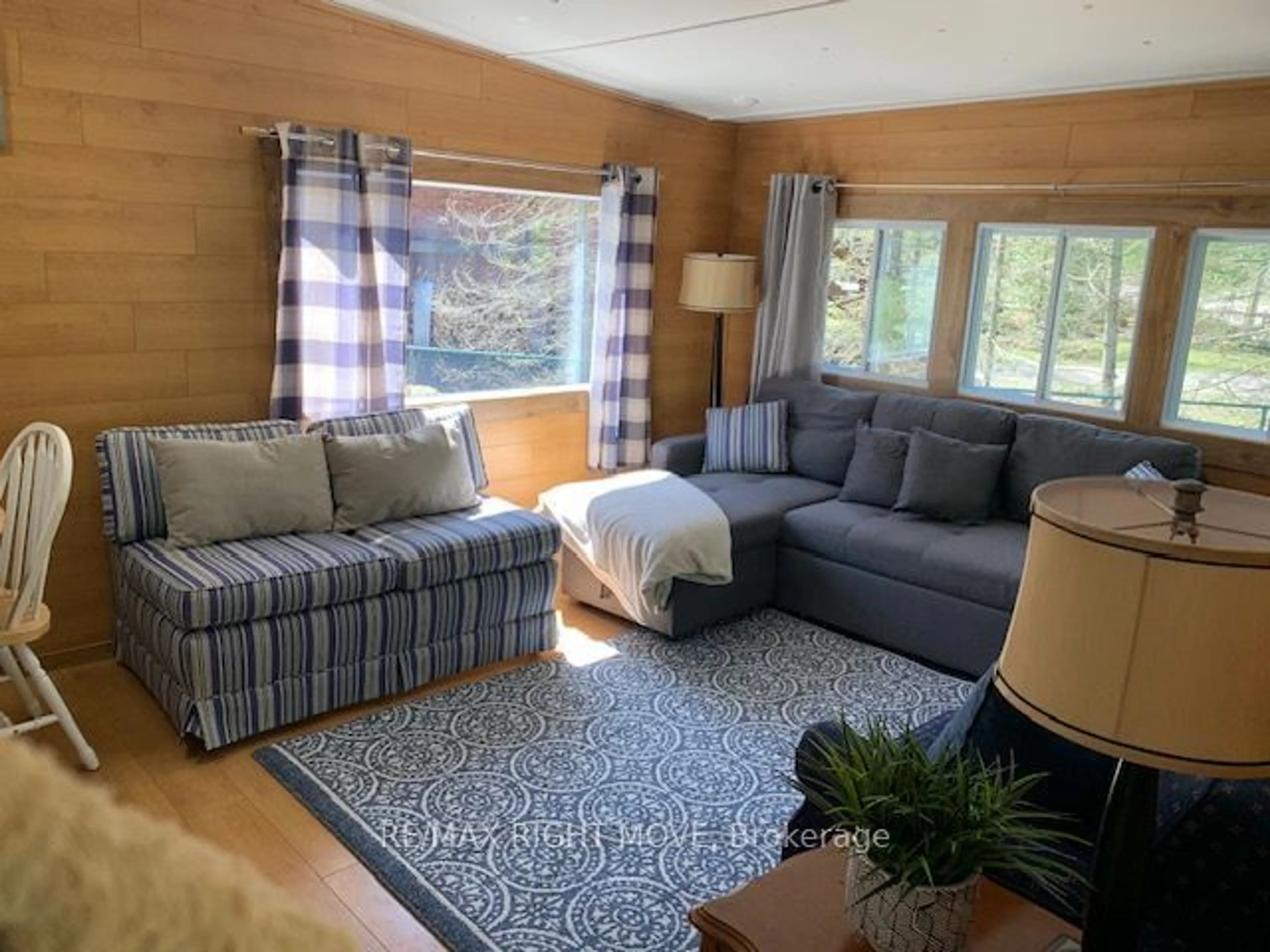 Living room with furniture, wood/laminate floor for 11 Stoney Rd, Tiny Ontario L9M 0H2