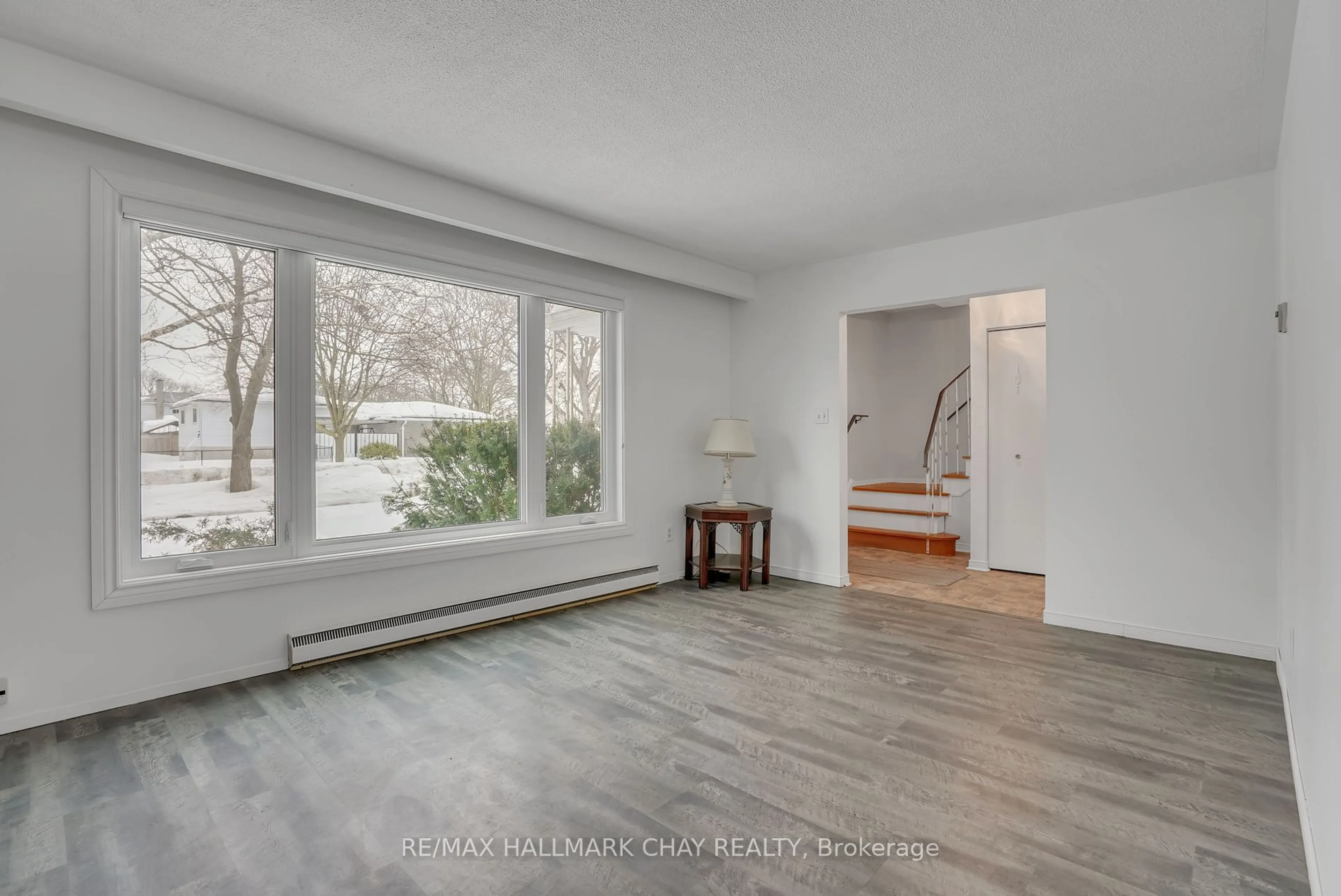 Living room with furniture, wood/laminate floor for 24 Clover Ave, Barrie Ontario L4N 3M6