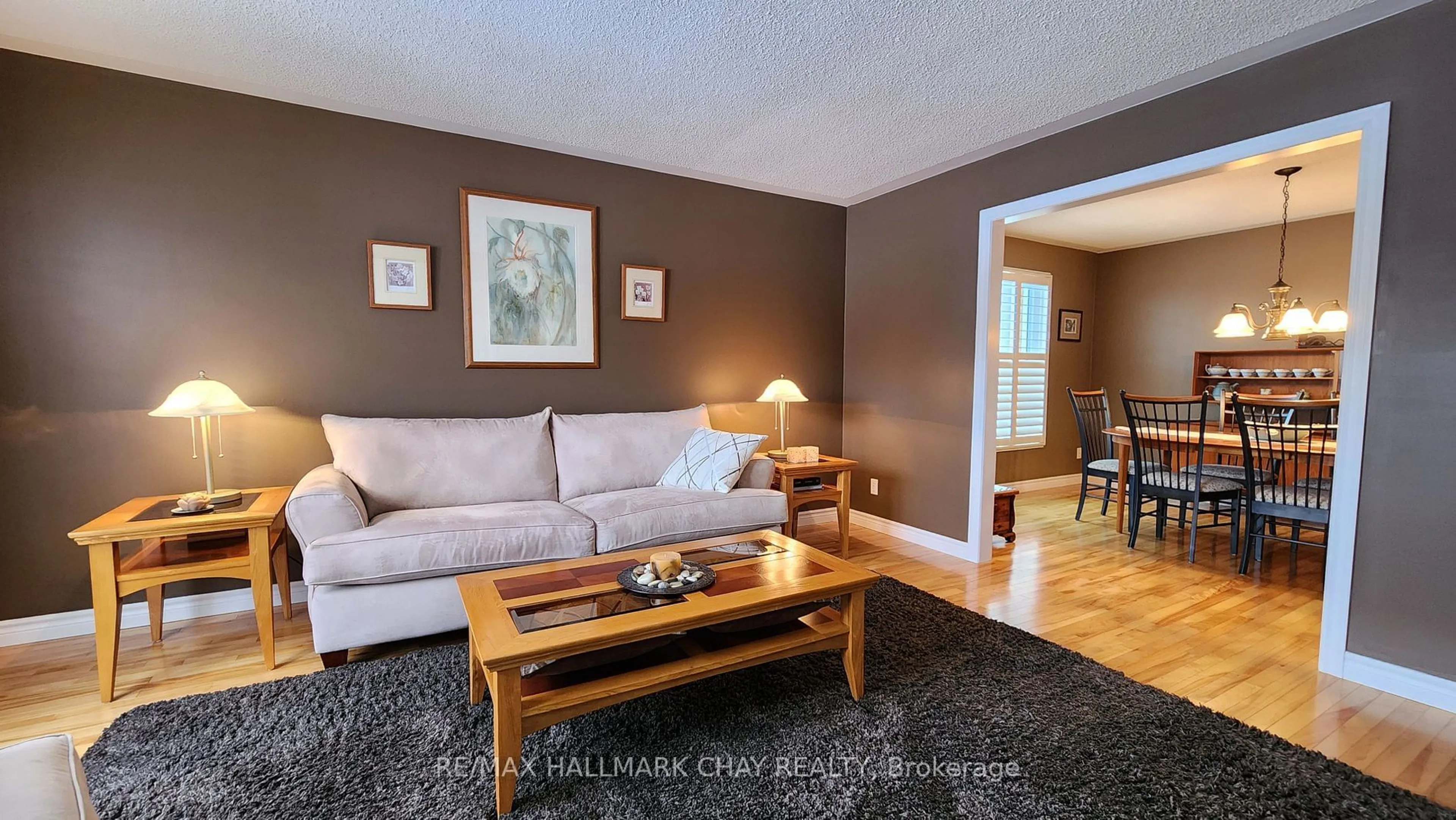 Living room with furniture, wood/laminate floor for 18 Dove Cres, Barrie Ontario L4N 7Z3