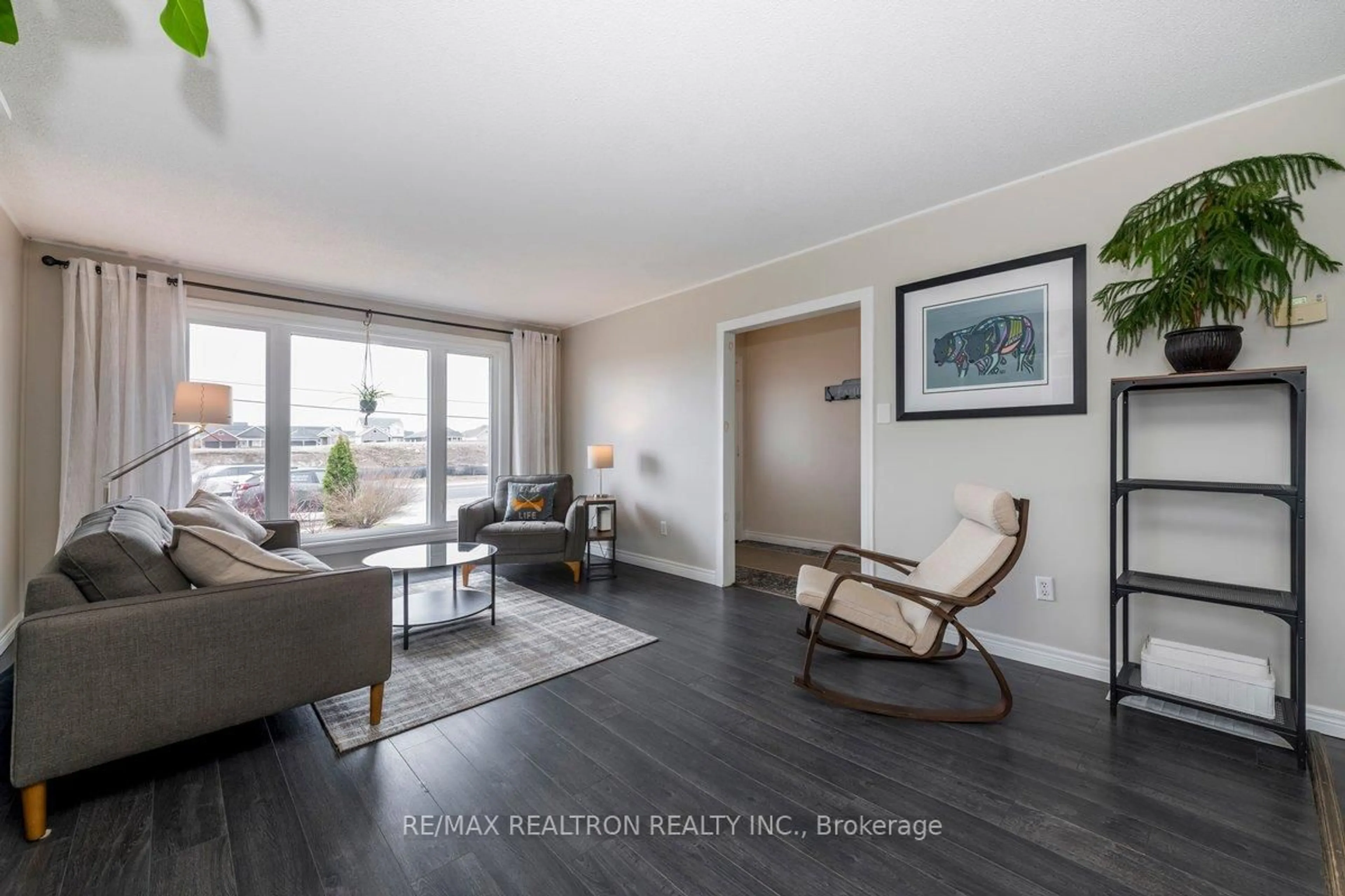 Living room with furniture, wood/laminate floor for 172 Queen St, Springwater Ontario L0L 1P0