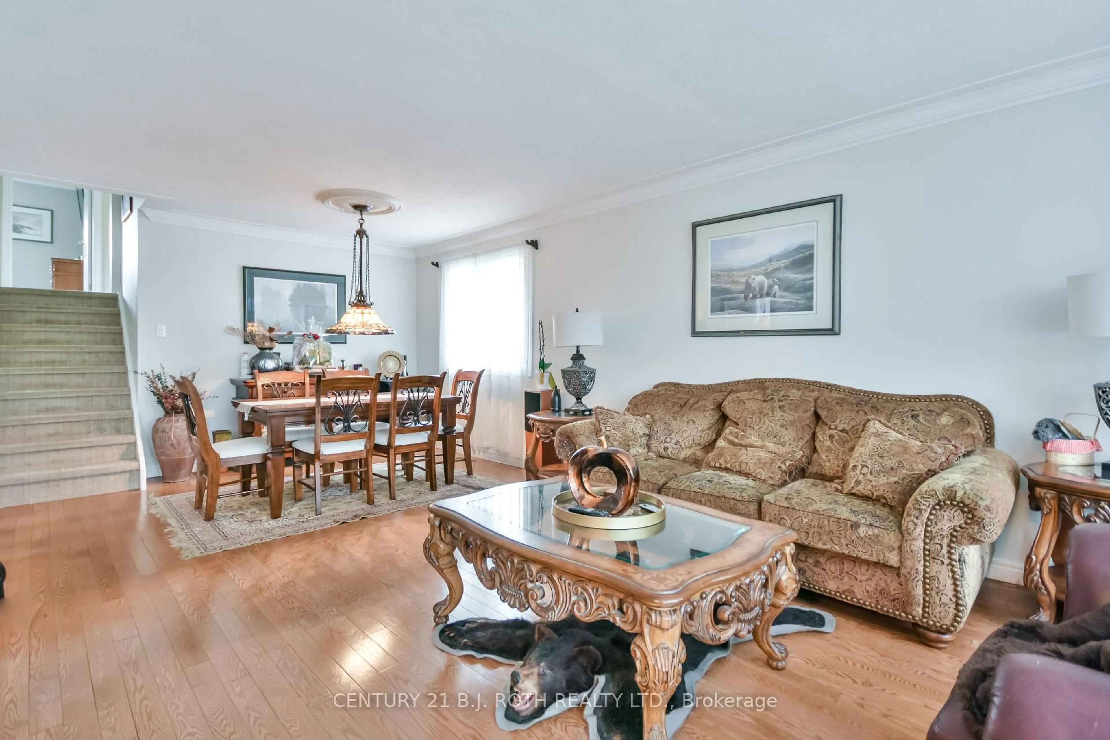 Living room with furniture, wood/laminate floor for 233 Rose St, Barrie Ontario L4M 2V3
