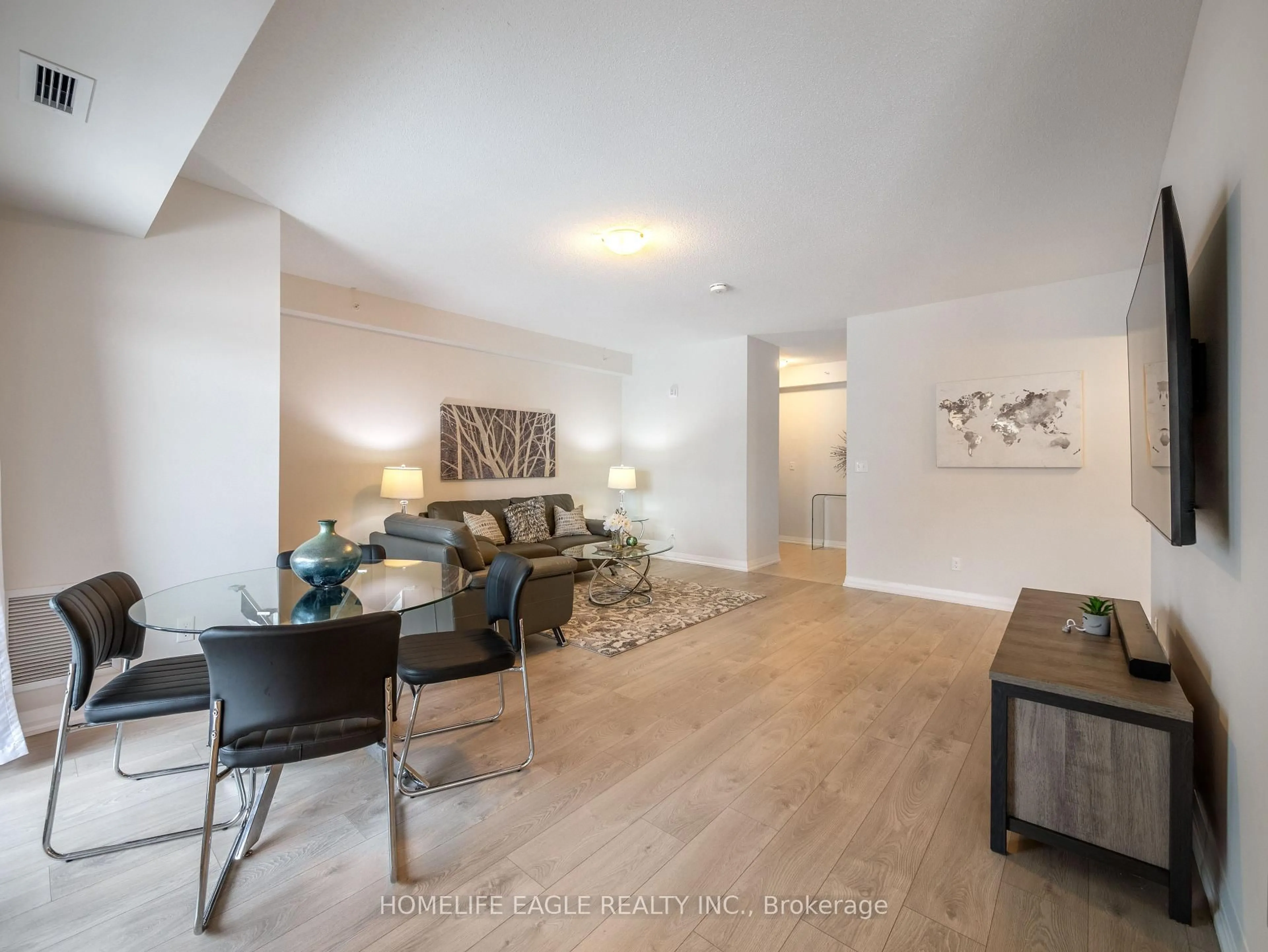 Living room with furniture, wood/laminate floor for 20 Koda St #211, Barrie Ontario L9J 0J7