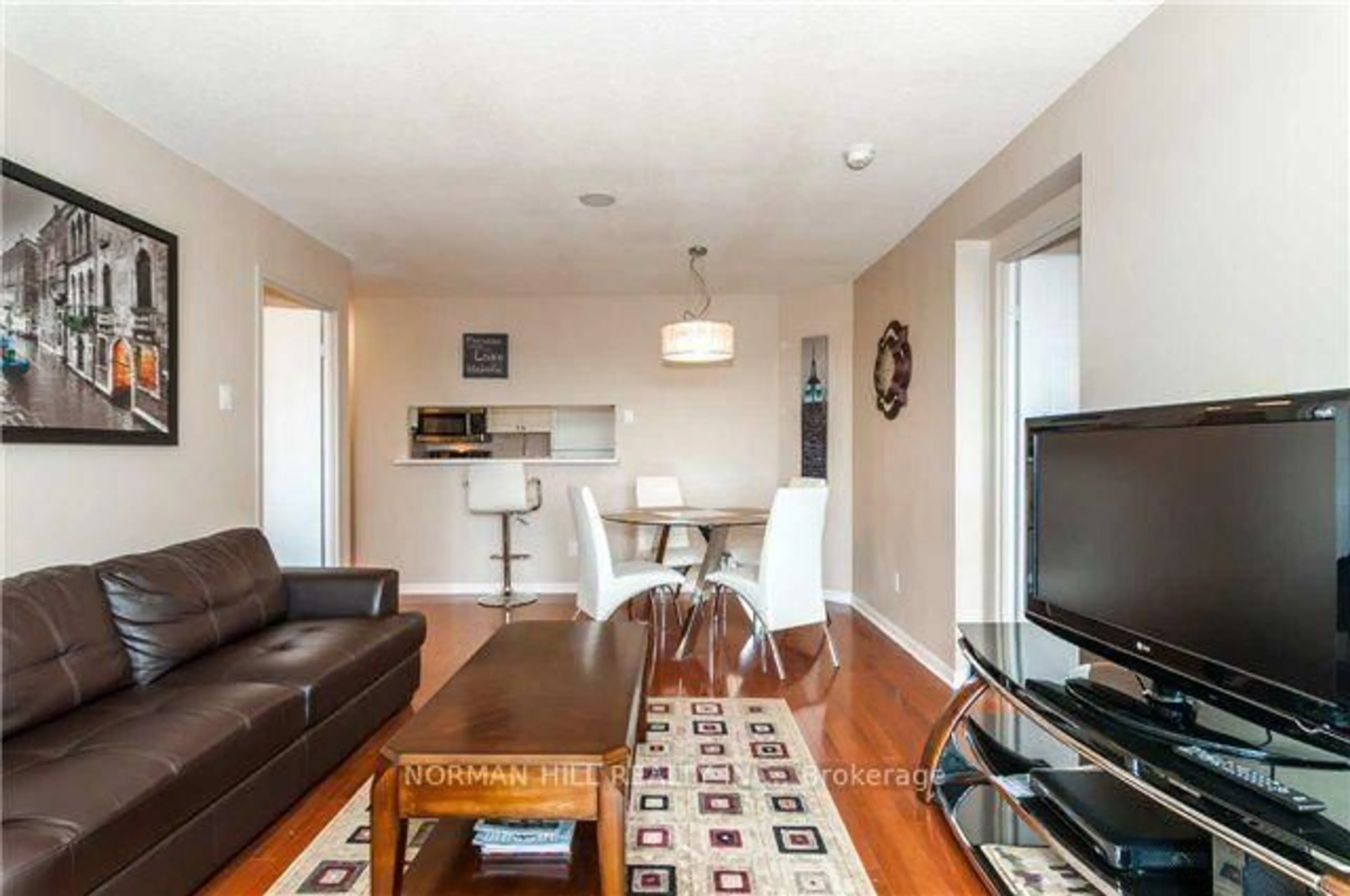 Living room with furniture, wood/laminate floor for 75 Ellen St #1111, Barrie Ontario L4N 7R6