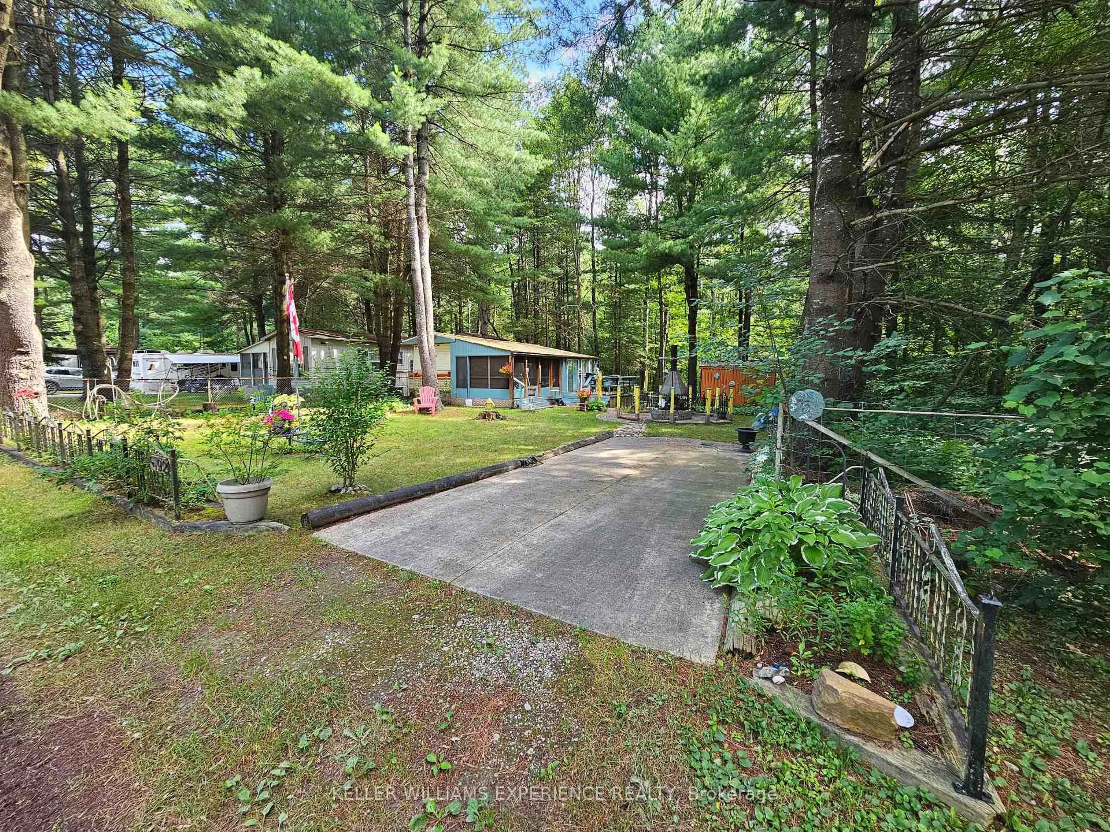 A pic from outside/outdoor area/front of a property/back of a property/a pic from drone, forest/trees view for 5216 County 90 Rd #92, Springwater Ontario L0M 1T0