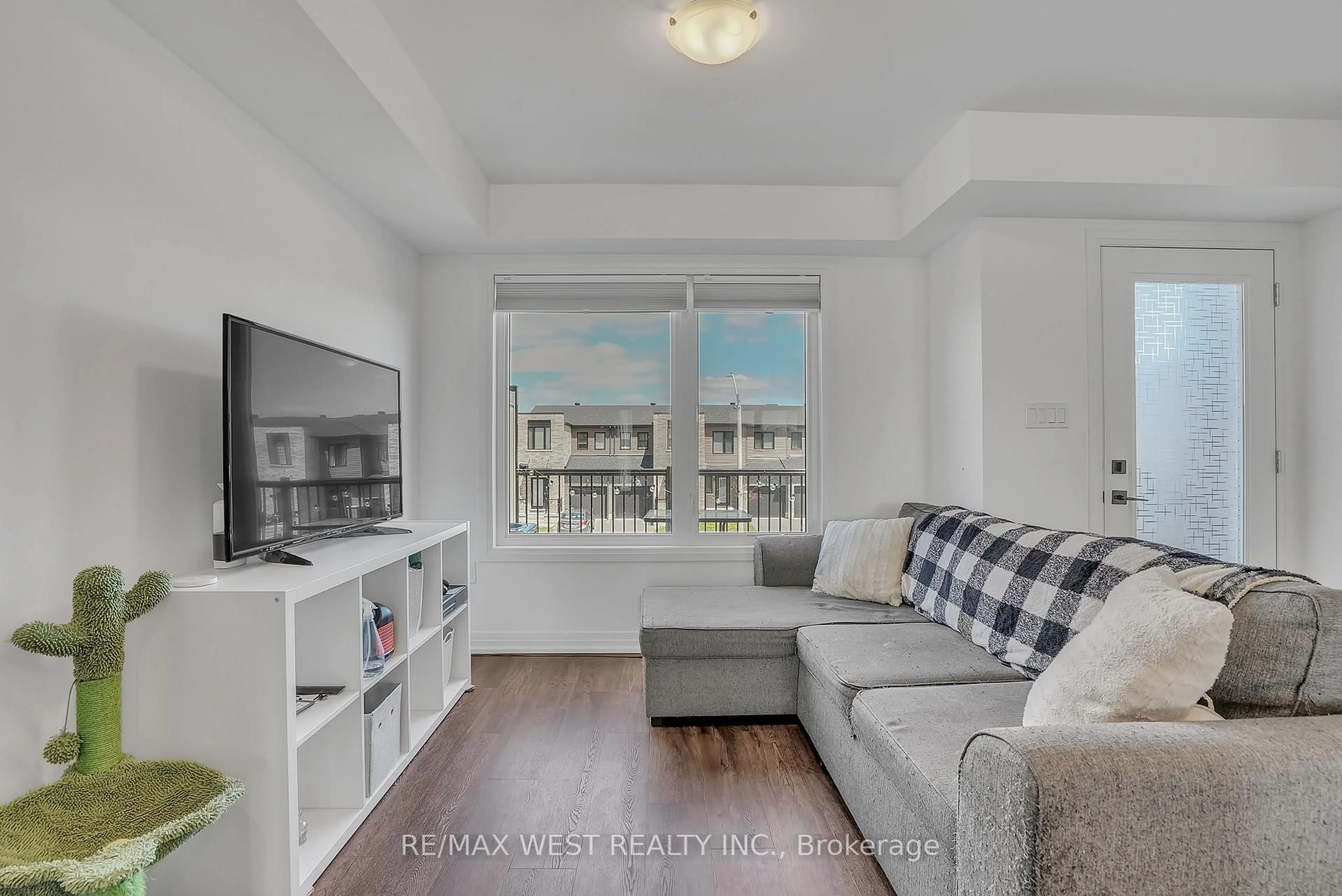 Living room with furniture, wood/laminate floor for 61 Fairlane Ave, Barrie Ontario L9J 0N1