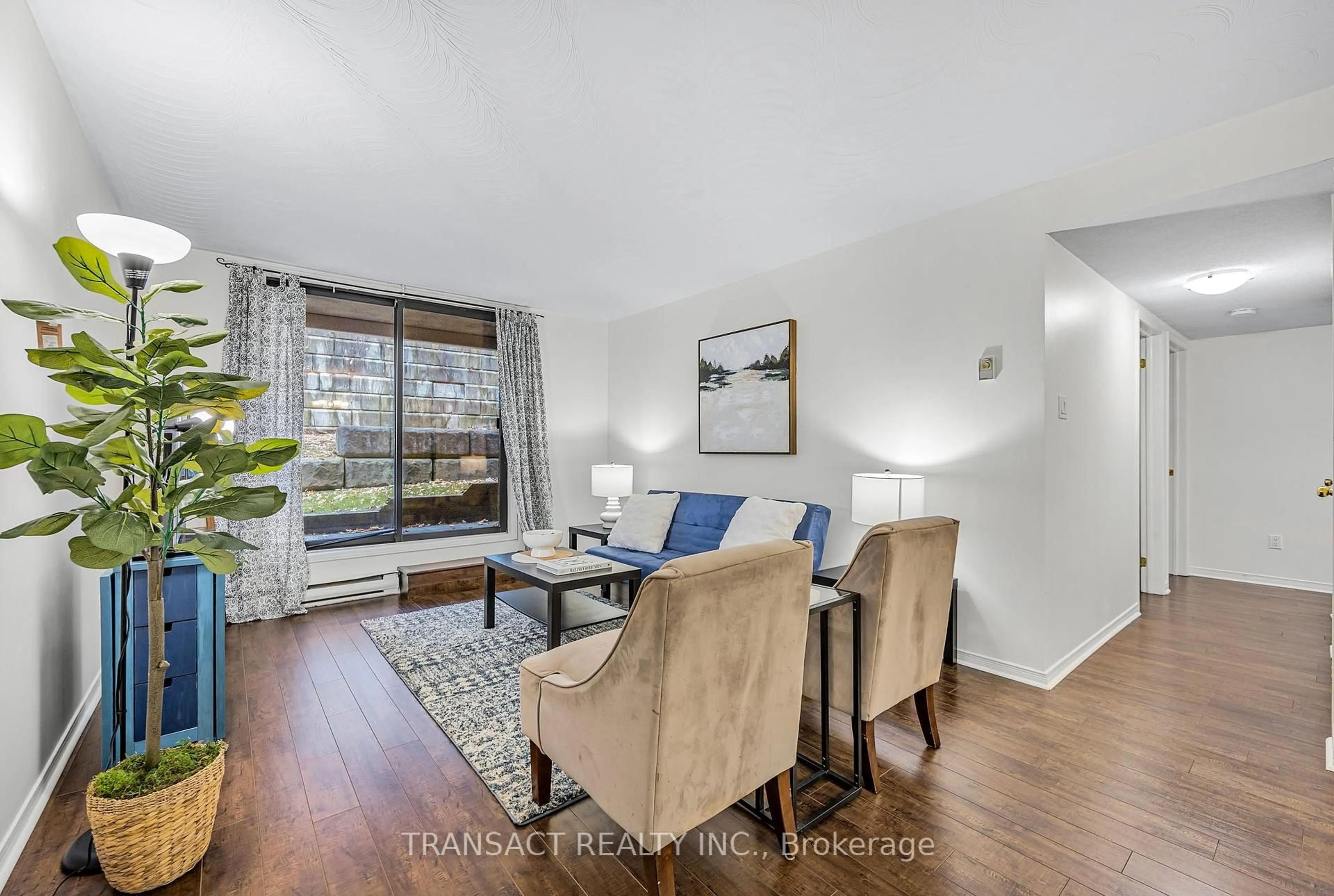 Living room with furniture, wood/laminate floor for 25 Meadow Lane #108, Barrie Ontario L4N 7K2