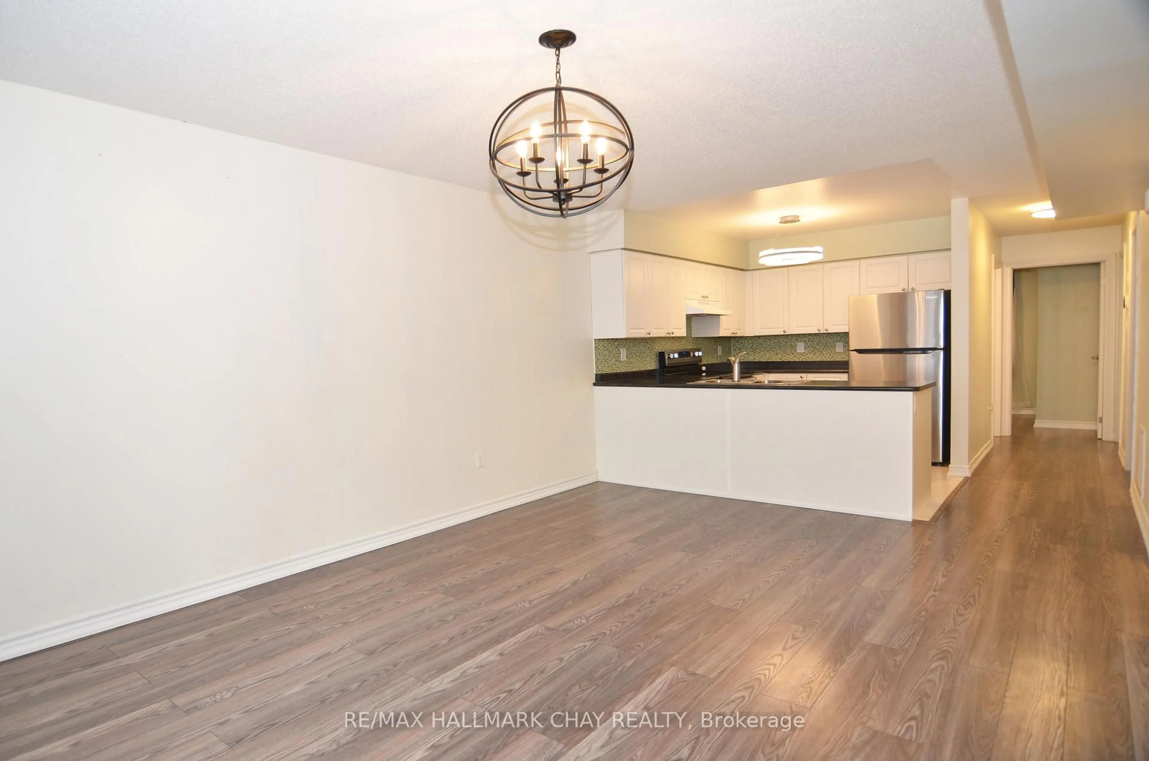 Open concept kitchen, wood/laminate floor for 49 Ferndale Dr #8, Barrie Ontario L4N 5W9