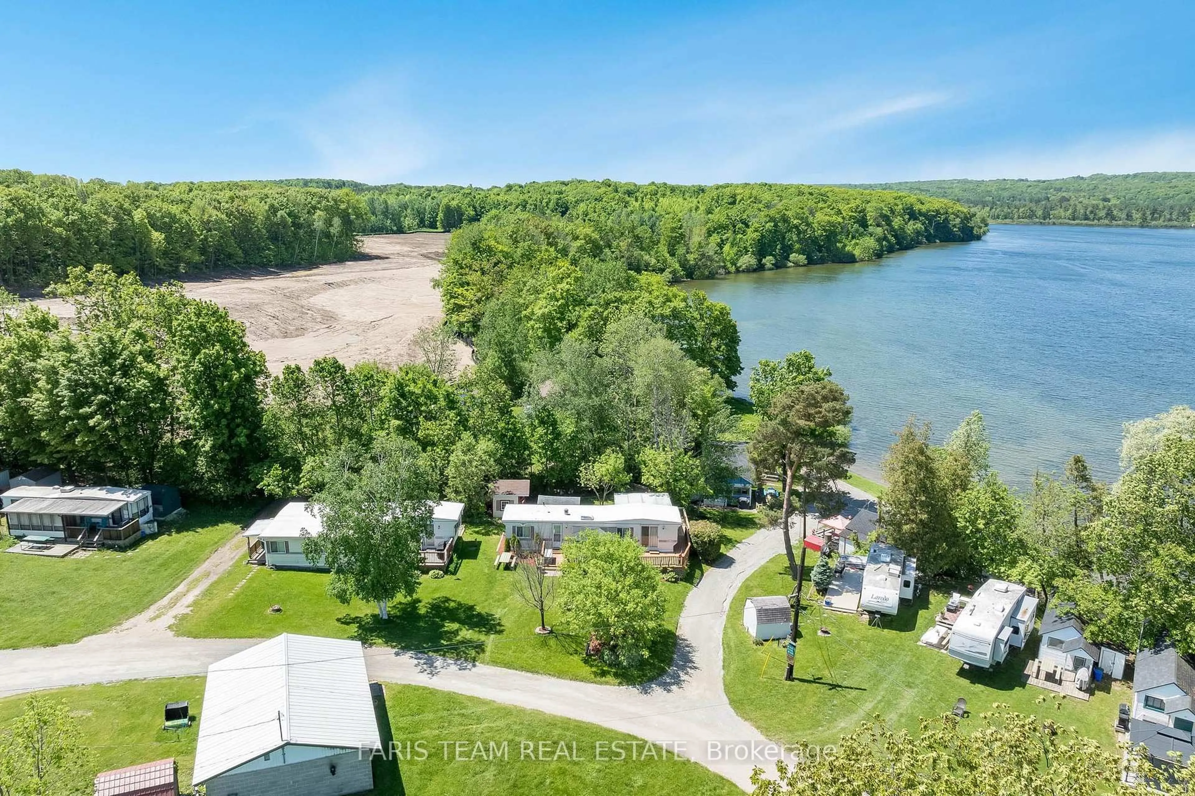 A pic from outside/outdoor area/front of a property/back of a property/a pic from drone, water/lake/river/ocean view for 79 Stans Circ, Midland Ontario L4R 0B9