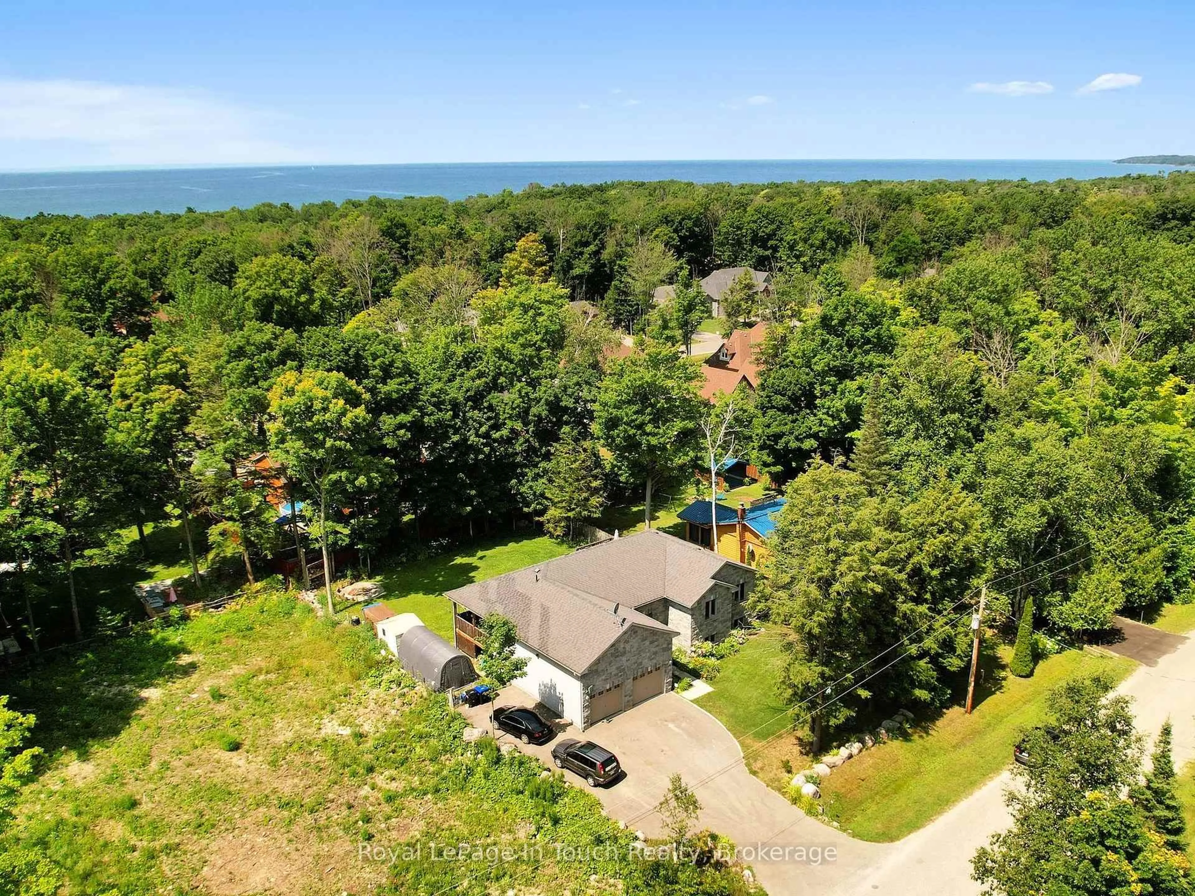 A pic from outside/outdoor area/front of a property/back of a property/a pic from drone, water/lake/river/ocean view for 122 Trout Lane, Tiny Ontario L9M 0J1