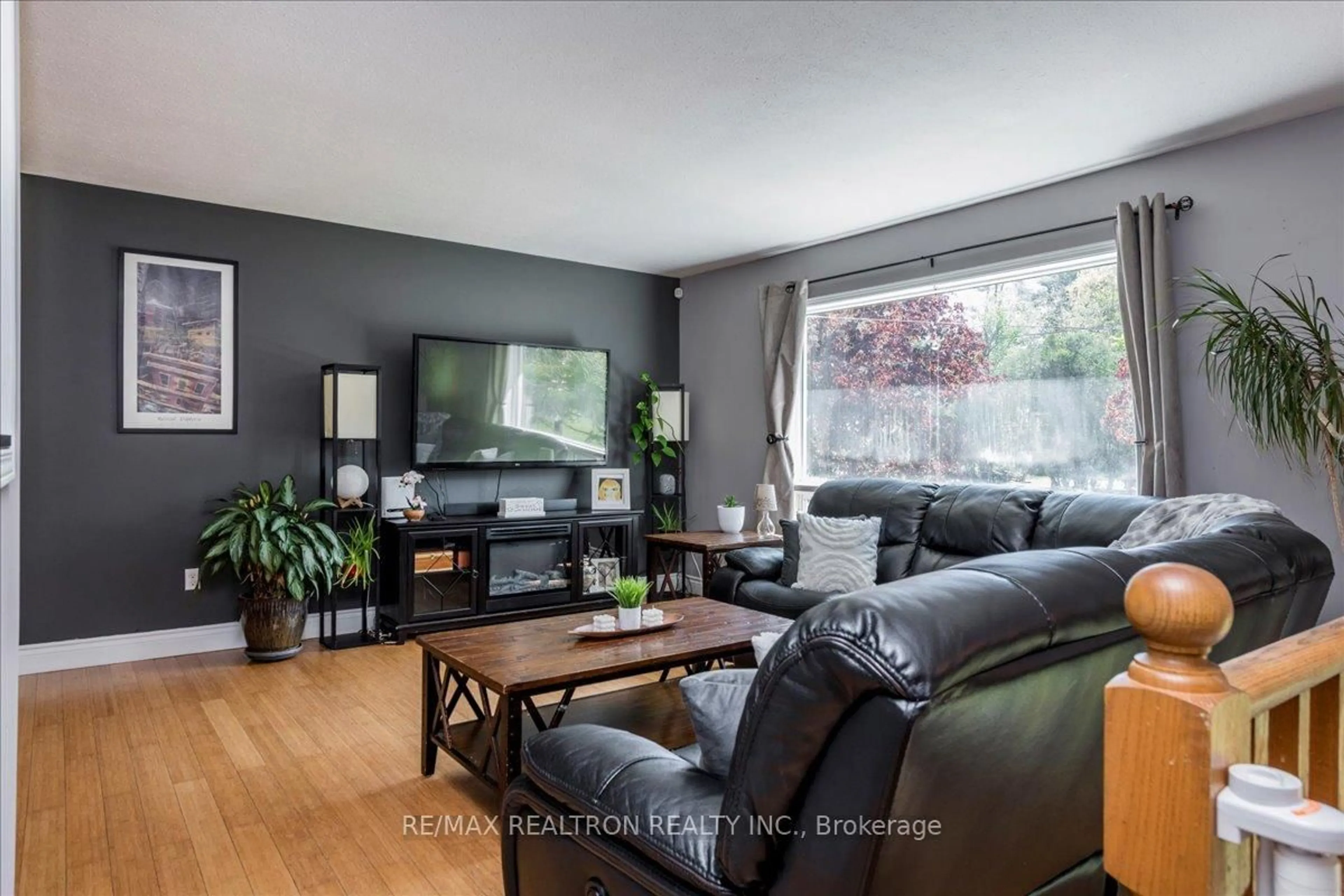 Living room with furniture, wood/laminate floor for 3974 Horseshoe Valley Rd, Springwater Ontario L0L 1Y0
