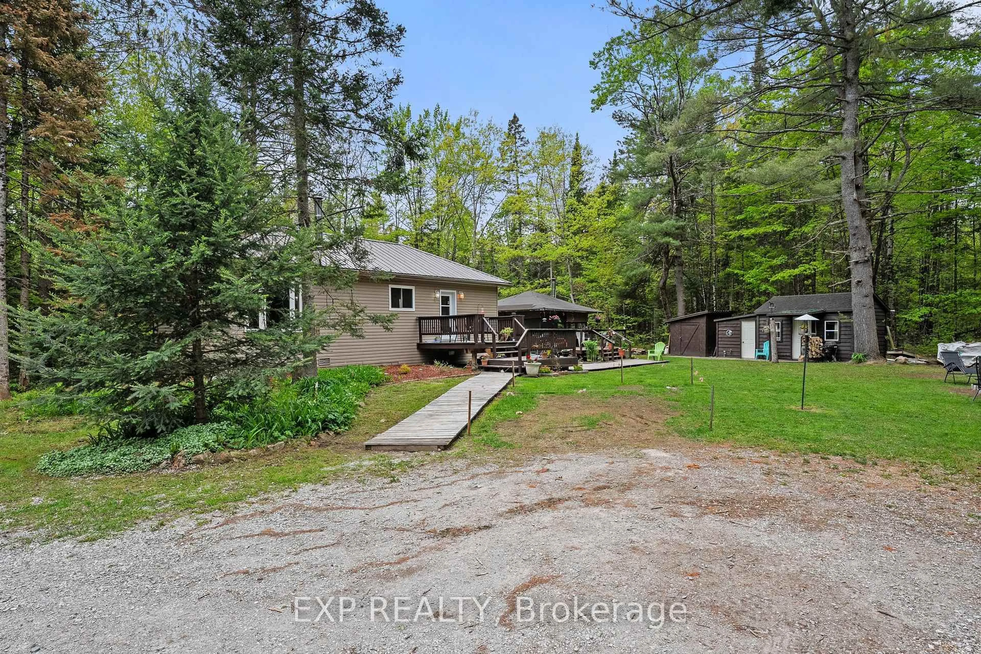 A pic from outside/outdoor area/front of a property/back of a property/a pic from drone, forest/trees view for 6566 Pioneer Village Lane, Ramara Ontario L0K 1W0