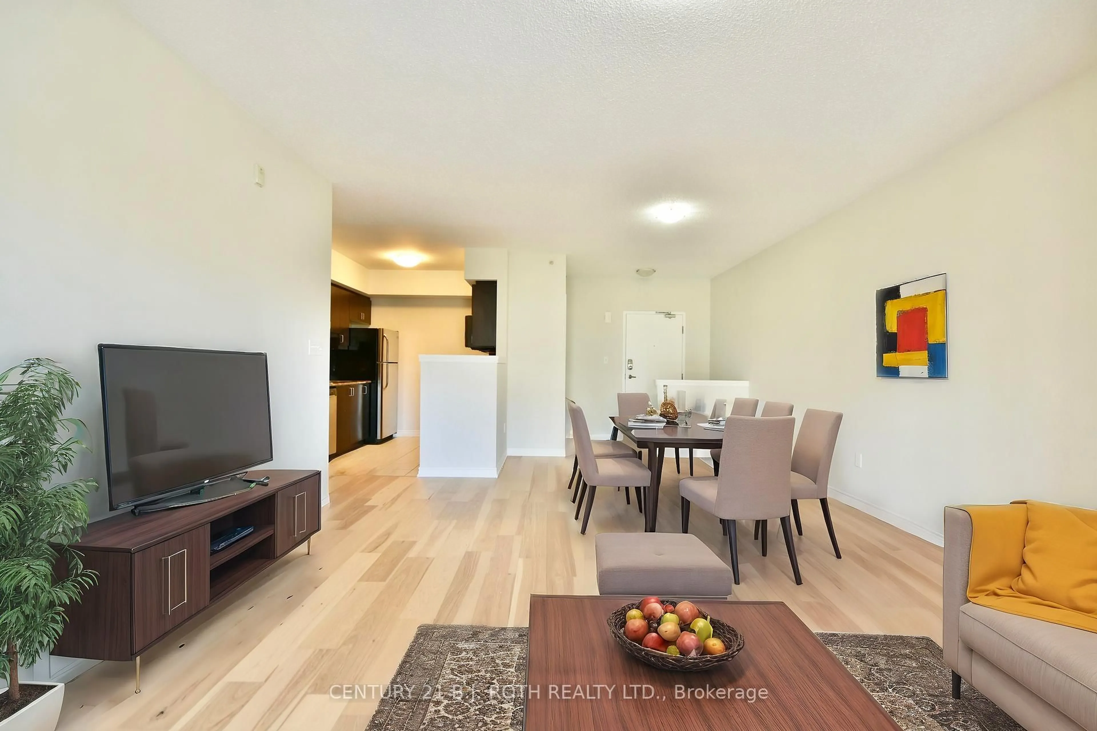 Living room with furniture, wood/laminate floor for 39 Ferndale Dr #205, Barrie Ontario L4N 5T5