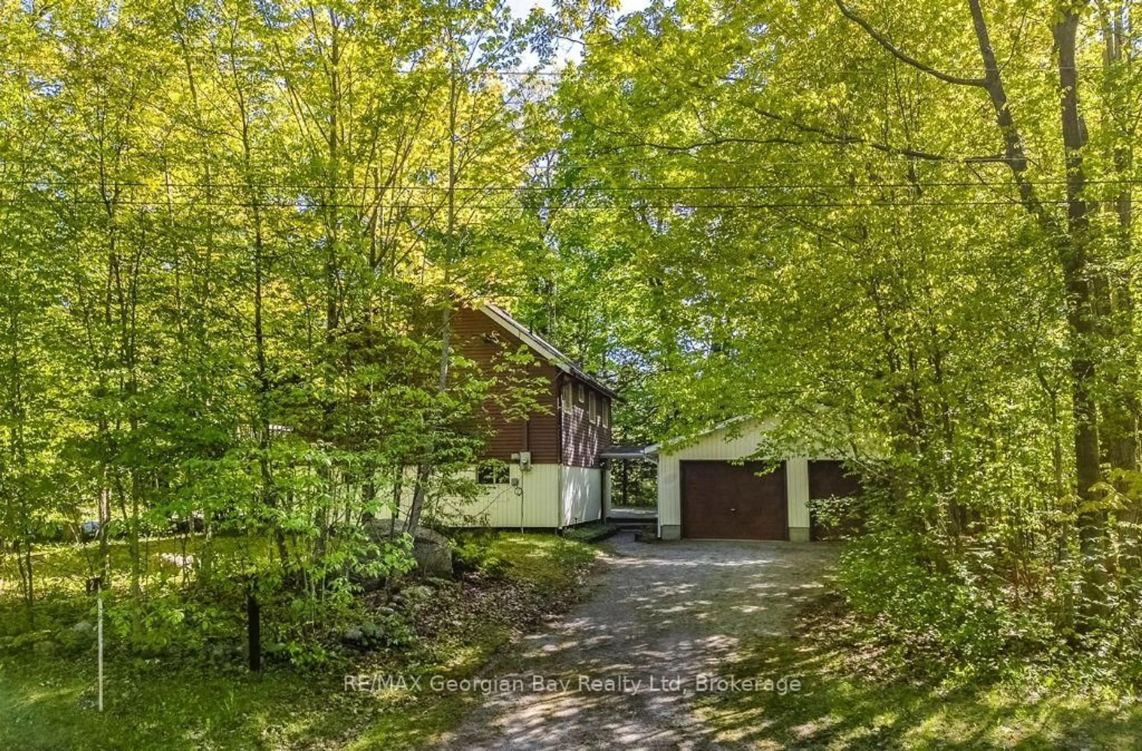 A pic from outside/outdoor area/front of a property/back of a property/a pic from drone, forest/trees view for 2 Manitou Cres, Tiny Ontario L9M 0C6