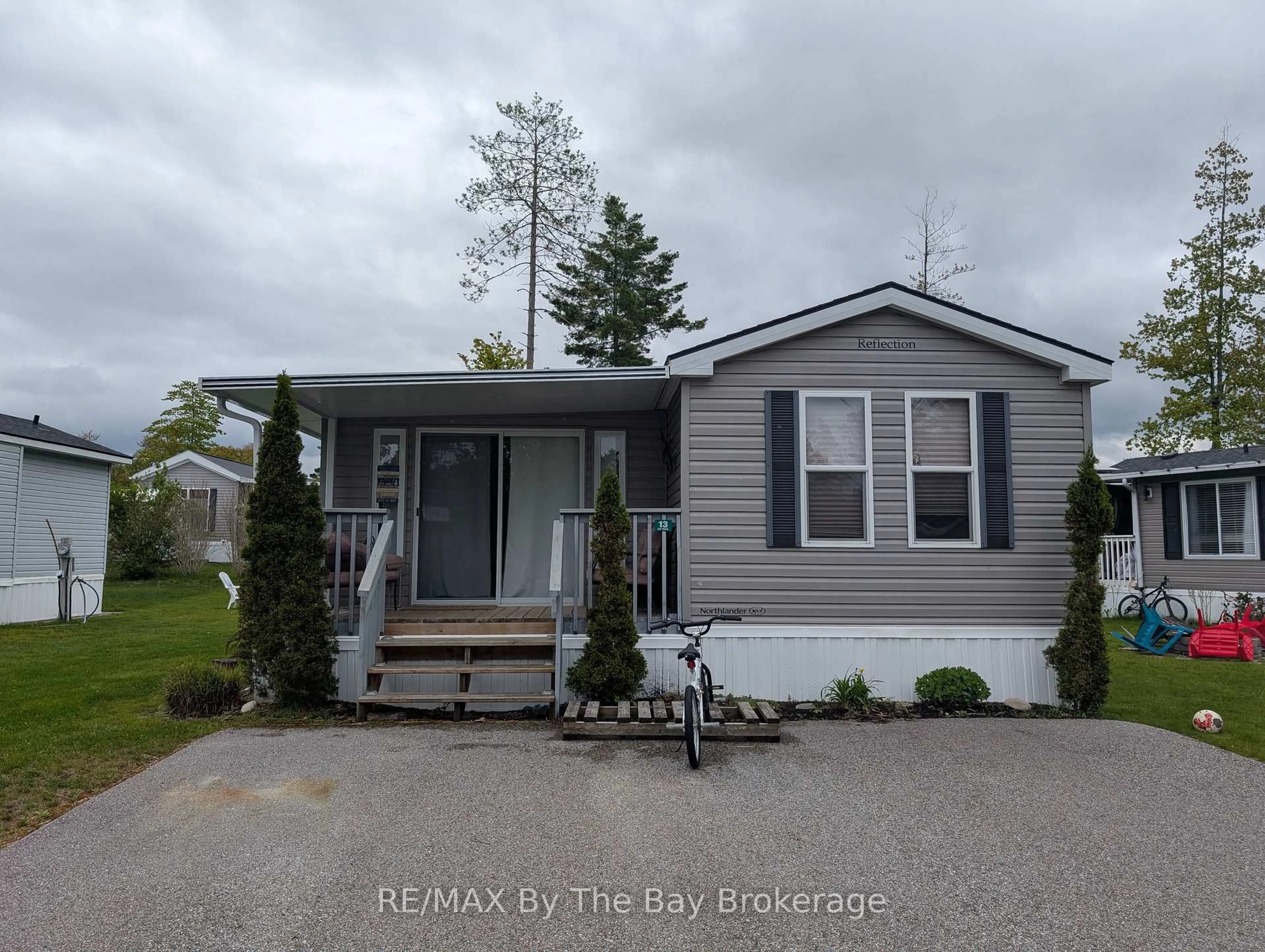 Home with vinyl exterior material, street for 13 CHIPPEWA Tr, Wasaga Beach Ontario L9Z 1X7