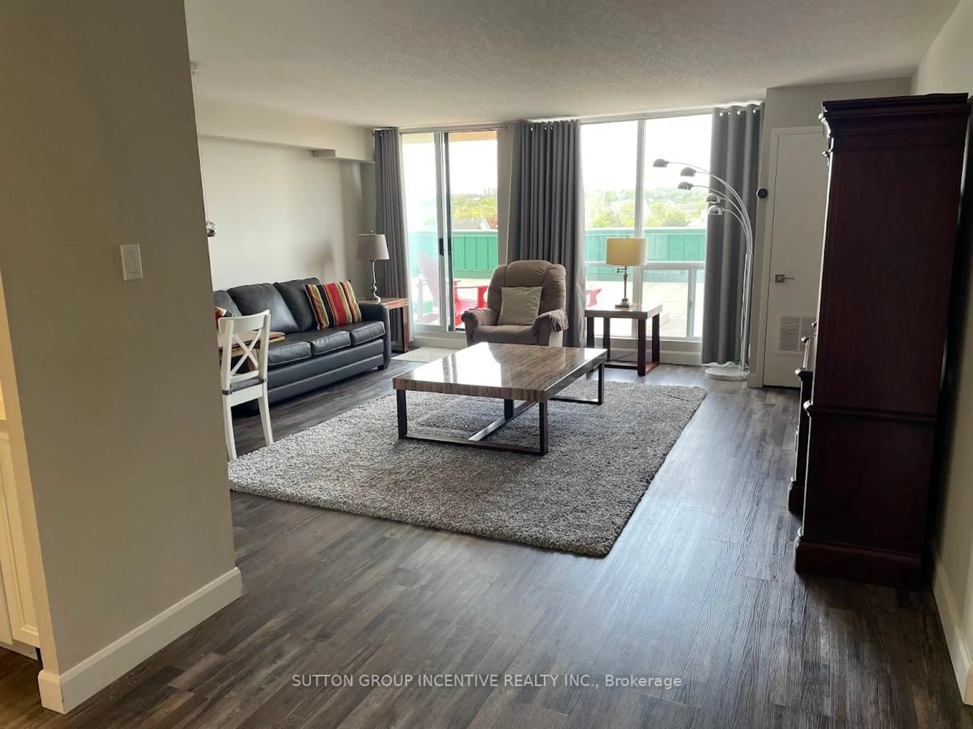 Living room with furniture, wood/laminate floor for 65 Ellen St #111, Barrie Ontario L4N 3A5