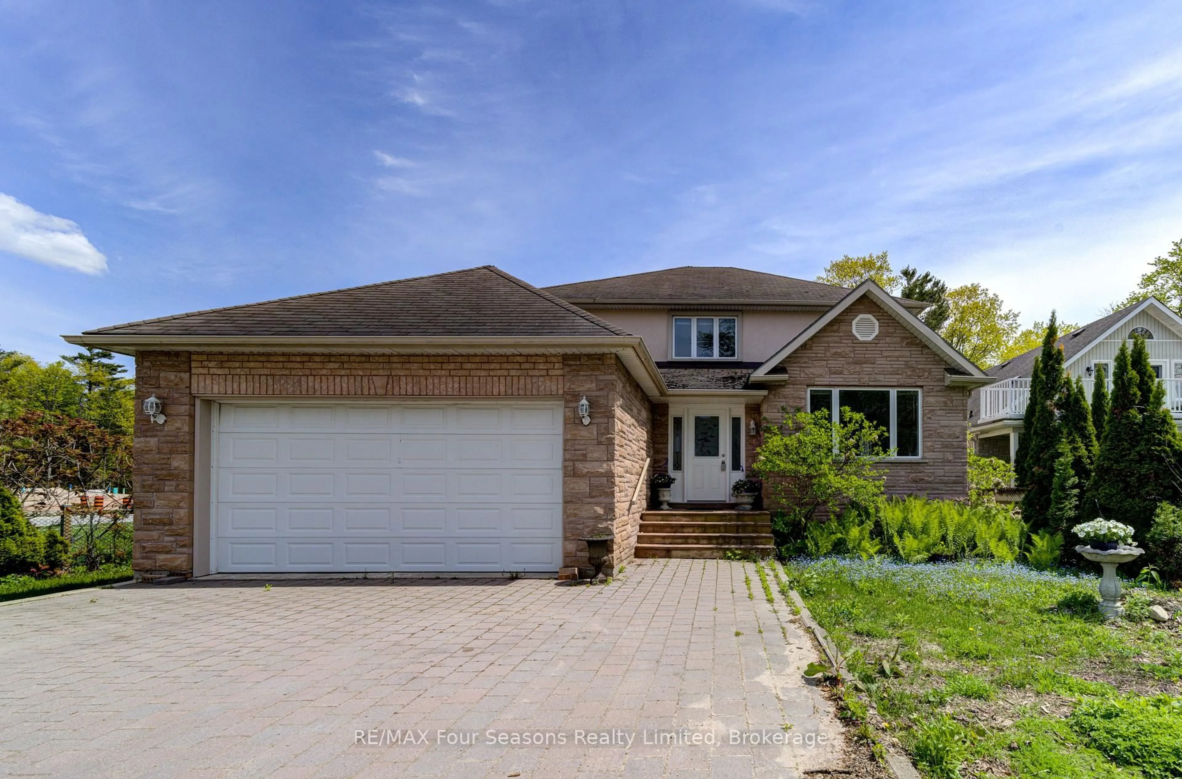 Home with brick exterior material, street for 243 River Rd, Wasaga Beach Ontario L9Z 2L1