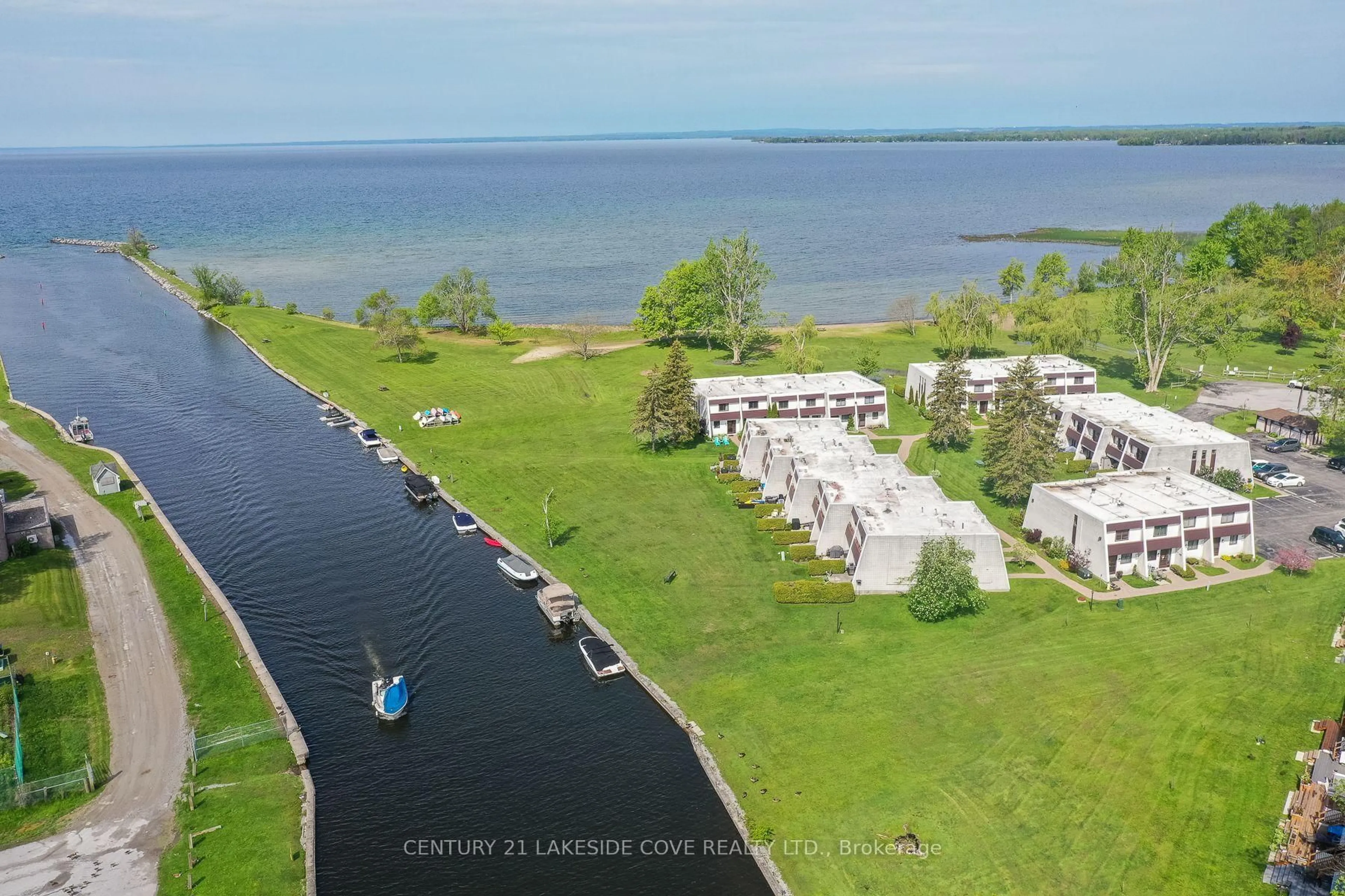 A pic from outside/outdoor area/front of a property/back of a property/a pic from drone, water/lake/river/ocean view for 1 Paradise Blvd #Unit 14, Ramara Ontario L0K 1B0