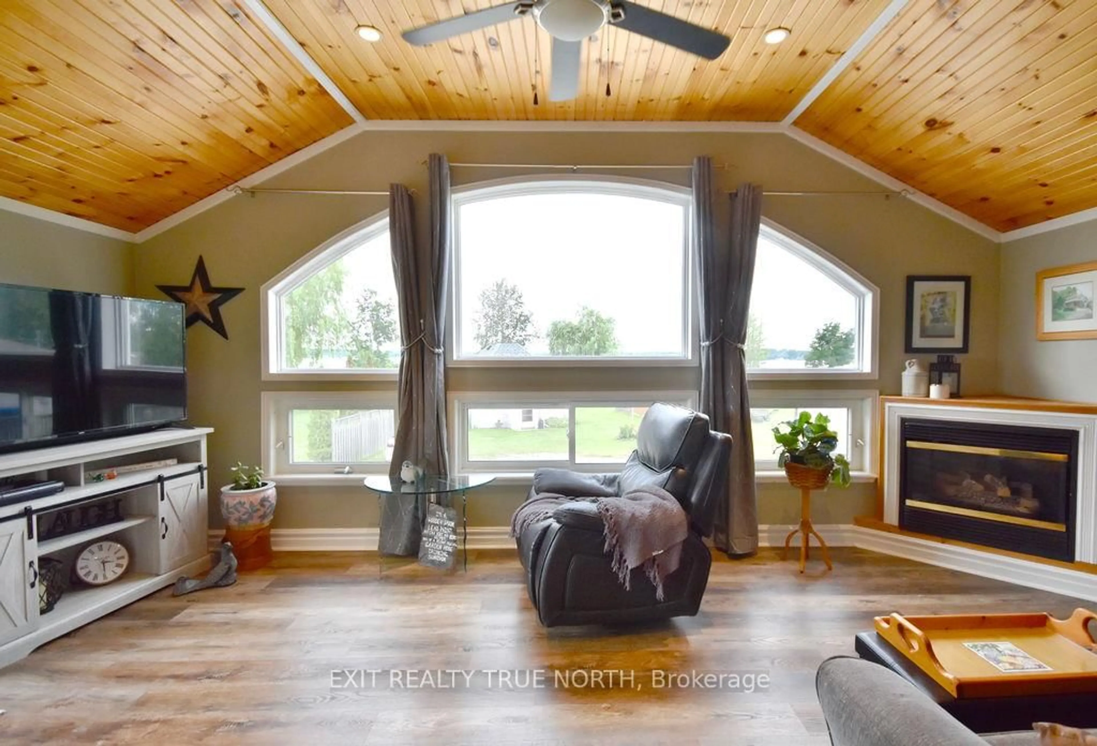 Living room with furniture, wood/laminate floor for 5632 Penetanguishene Rd, Springwater Ontario L0L 1P0