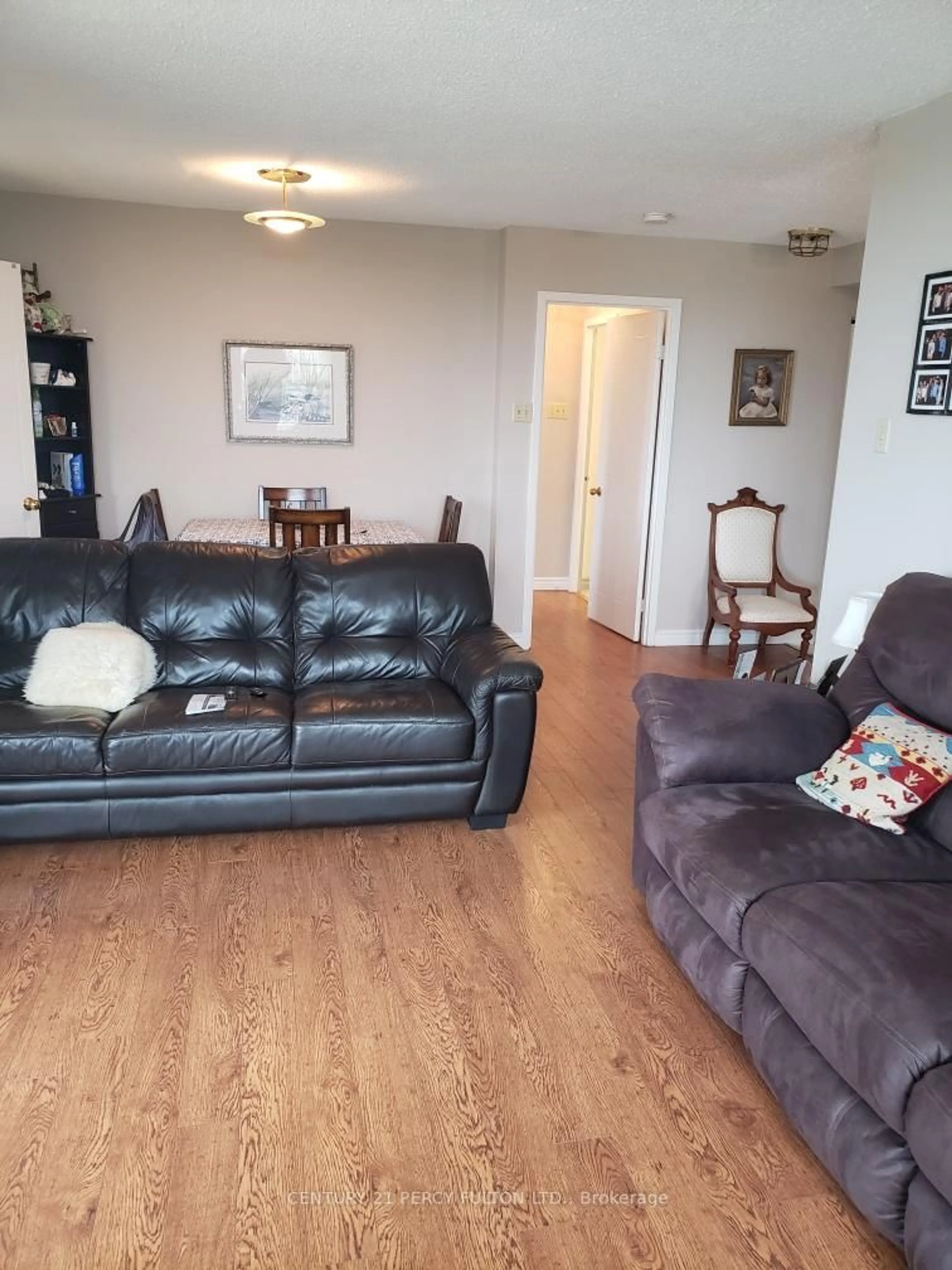 Living room with furniture, wood/laminate floor for 75 Ellen St #1004, Barrie Ontario L4N 7R6