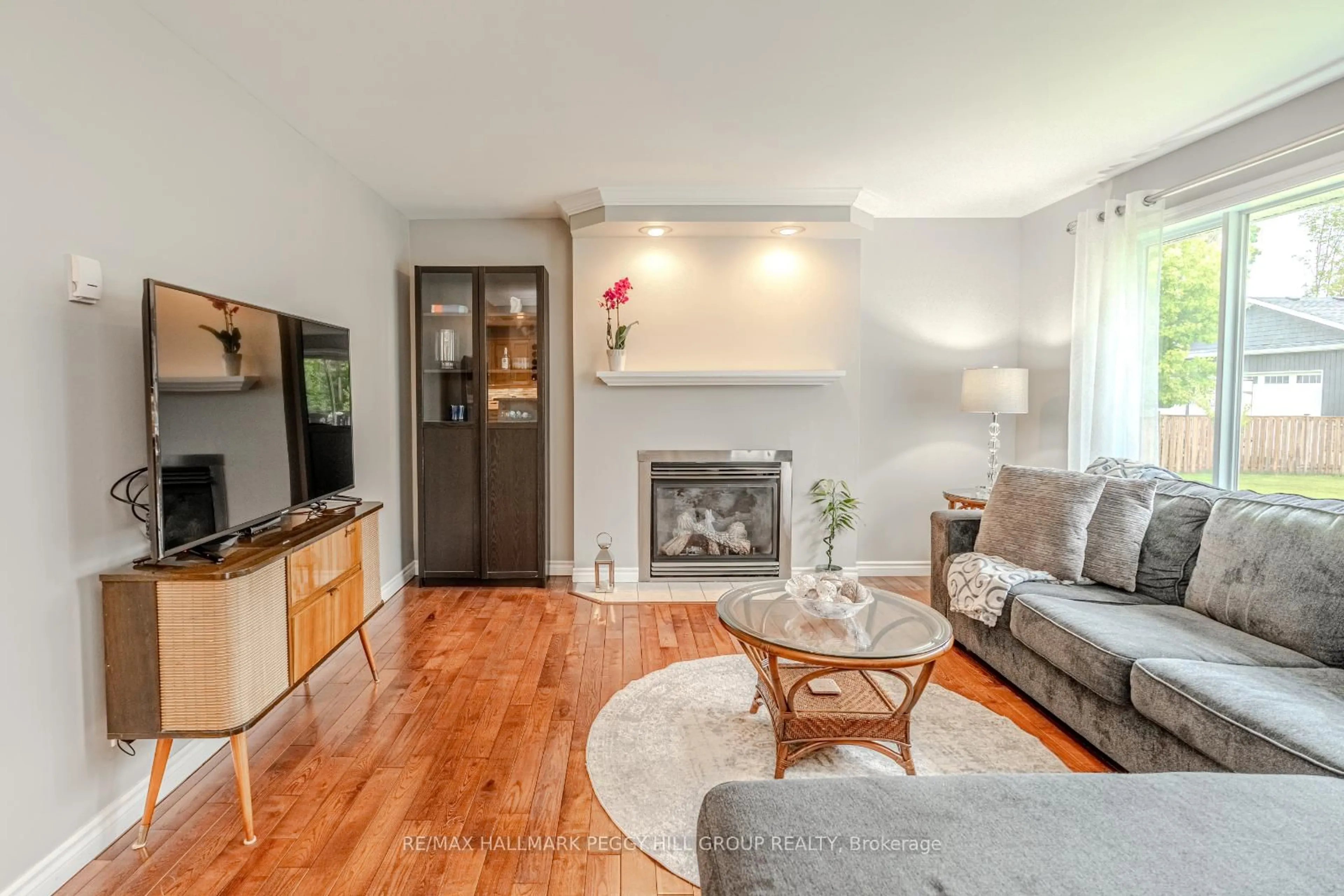 Living room with furniture, wood/laminate floor for 4653 Kurtis Dr, Ramara Ontario L3V 0K8