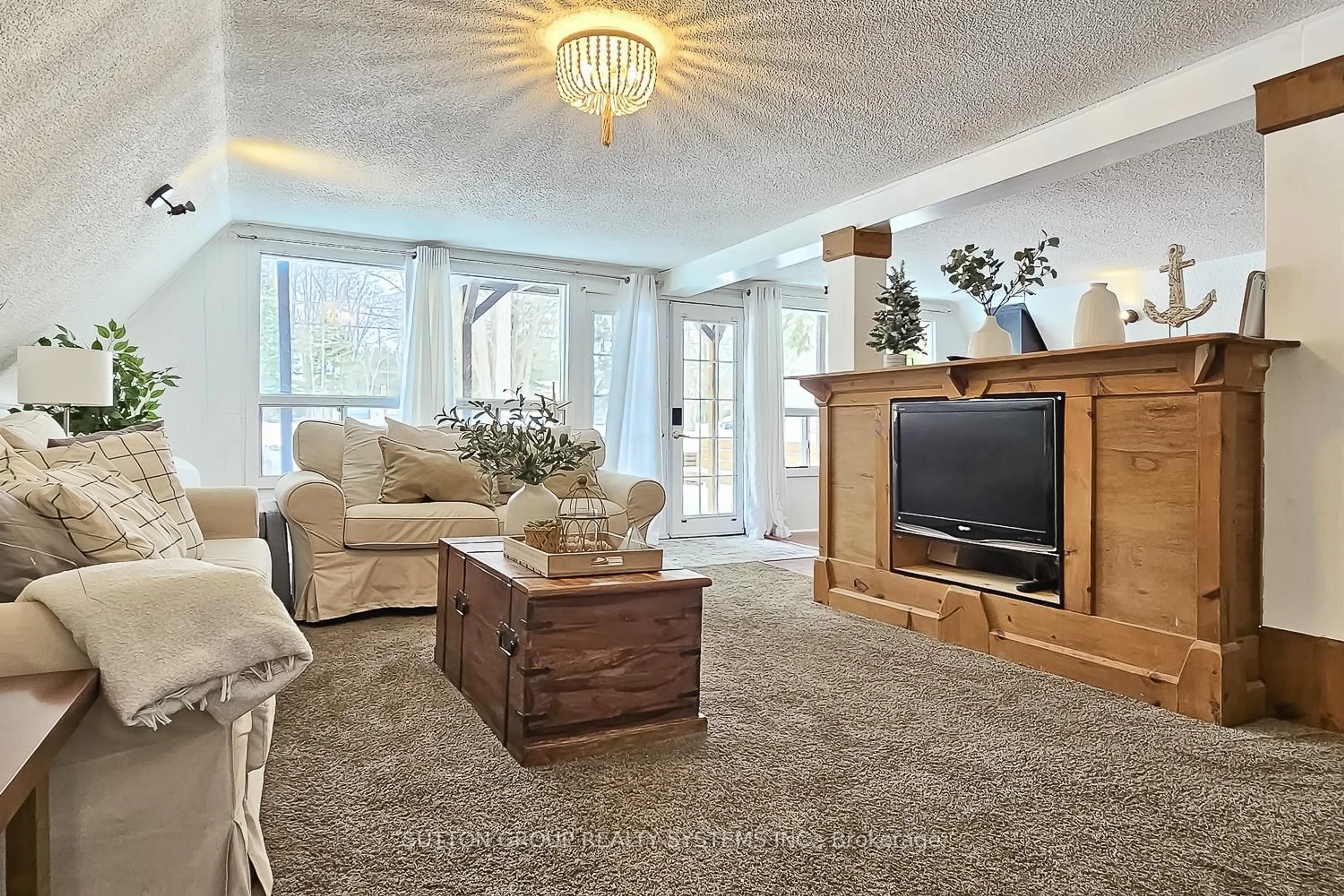 Living room with furniture, carpet floor for 1670 Mosley St, Wasaga Beach Ontario L9Z 2A1