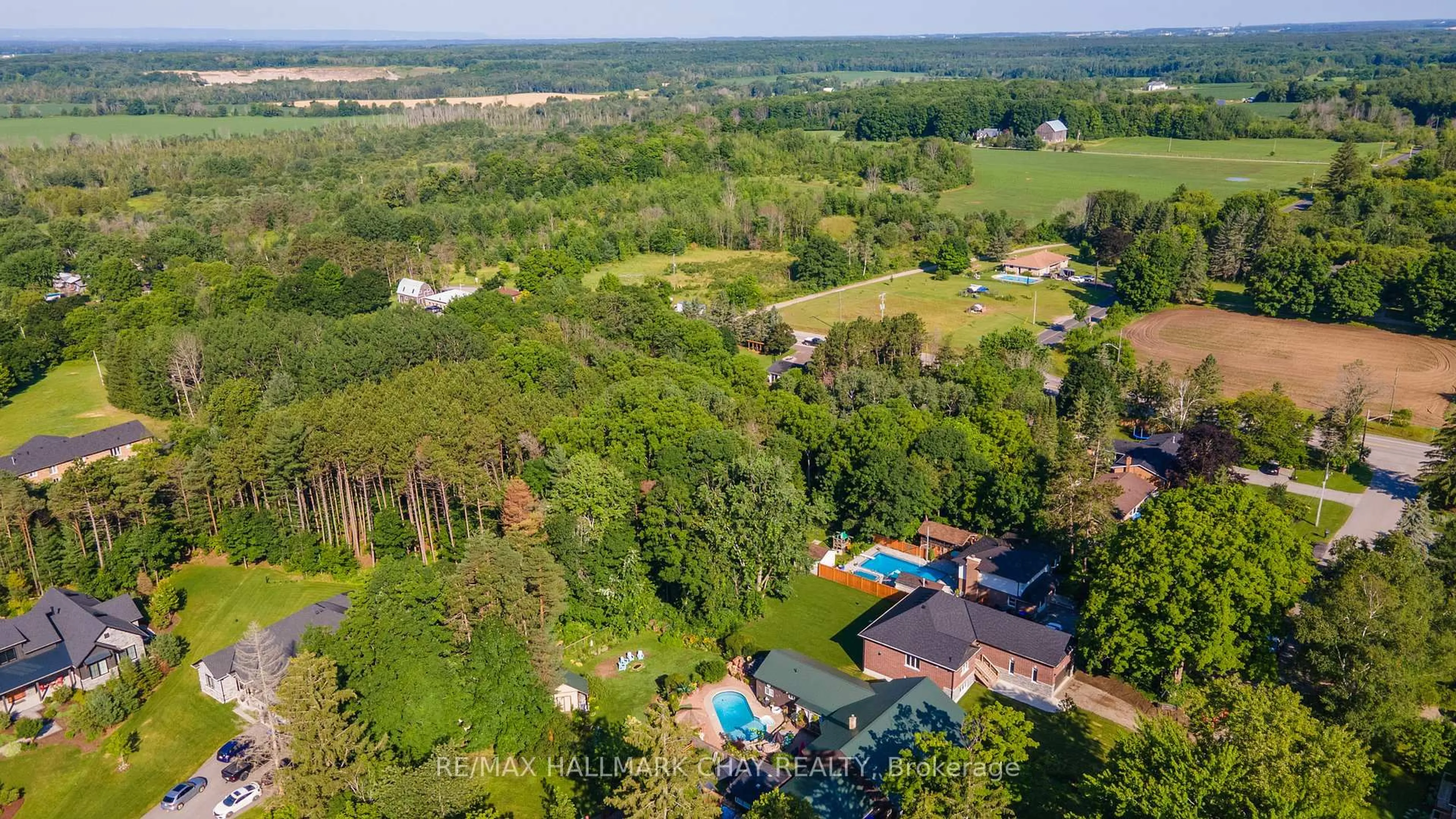 A pic from outside/outdoor area/front of a property/back of a property/a pic from drone, forest/trees view for 8 Alexander St, Springwater Ontario L3V 3T8
