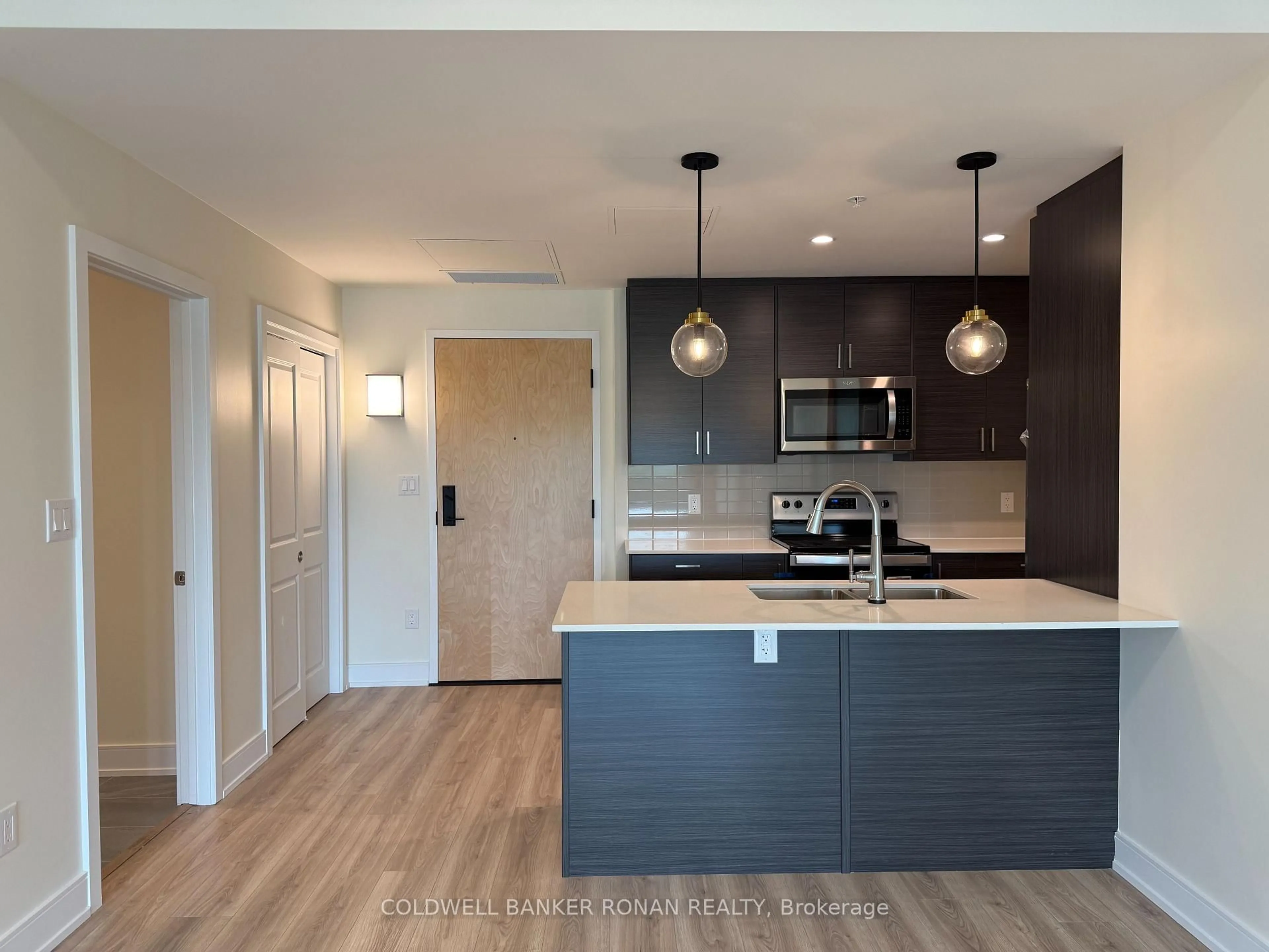 Open concept kitchen, wood/laminate floor for 121 Mary St #319, Clearview Ontario L0M 1G0